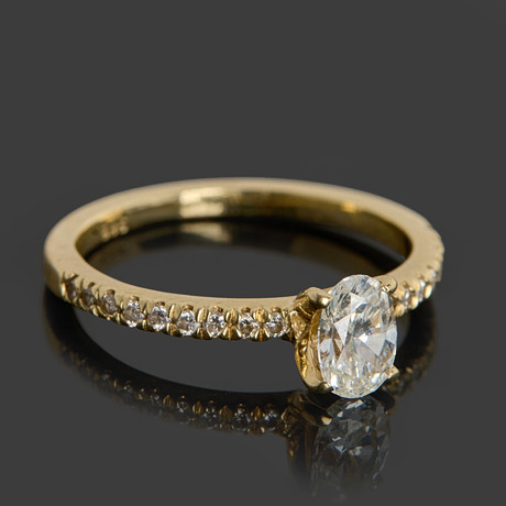 RING, 14k guld dekorerat med en ovalslipad diamant ca 0.54ct, 18 st briljanter totalt ca 0.18ct, certifikat me på auktion hos Crafoord Auktioner Stockholm