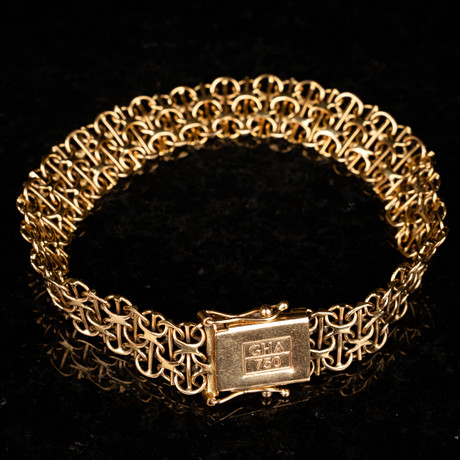 ARMBAND / KRYSSLÄNK. 18K Guld 1900-tal. på auktion hos Norrlands Auktionsverk