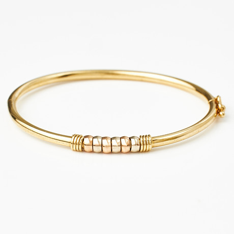ARMRING, 18 k trefärgat guld, trois couleurs, mittparti med 6 rörliga lameller, italienska stämplar. på auktion hos Stockholms Auktionsverk Magasin 5