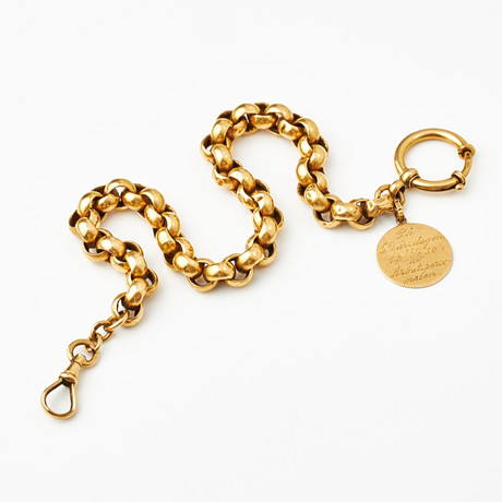KLOCKKEDJA, med berlock, 18 k guld, ärtlänk, karbinhake, Annie Stenström, Norrköping 1930. på auktion hos Stockholms Auktionsverk Magasin 5