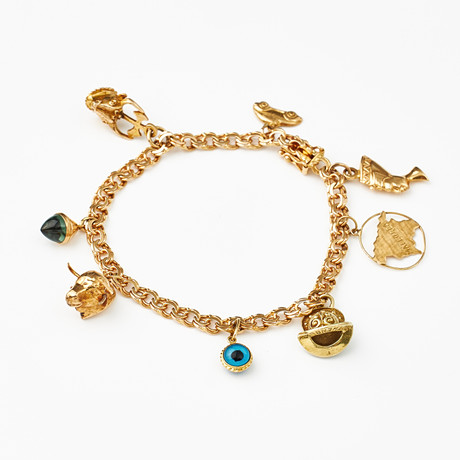 ARMBAND, 18 k guld, Bismarck, 8 berlocker bl a föreställande Nefertiti, Mallorcas silhuett, tjurhuvud, GK. Sto på auktion hos Stockholms Auktionsverk Magasin 5