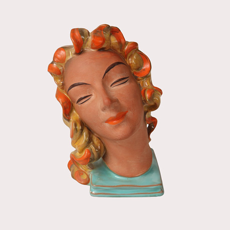 SKULPTUR i form av ett kvinnoansikte på sockel, delvis glaserad keramik, art deco, 1930- tal, märkt 14259. på auktion hos Limhamns Auktionsbyrå