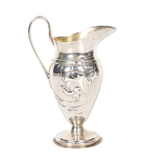 A LATE VICTORIAN SILVER CREAM JUG.