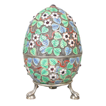 A RUSSIAN SILVER AND ENAMEL EGG ON STAND.