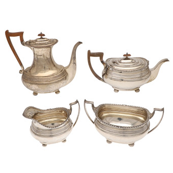 AN EARLY GEORGE V SILVER FOUR PIECE TEA SET.