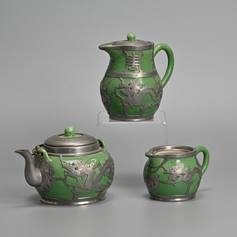 A CHINESE PEWTER-MOUNTED GREEN-GLAZED YIXING PART TEA-SERVICE, 20TH CENTURY, STAMPED HSIN HOCHENG TO MOUNTS.