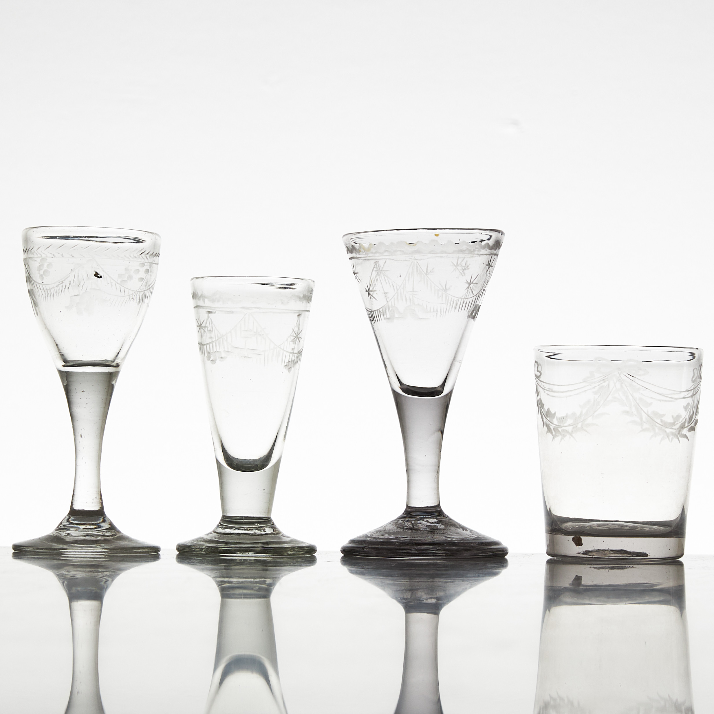 GLAS, 4 stycken, sengustavianska av olika modeller, 1800-talets början, kasad dekor av girlanger.