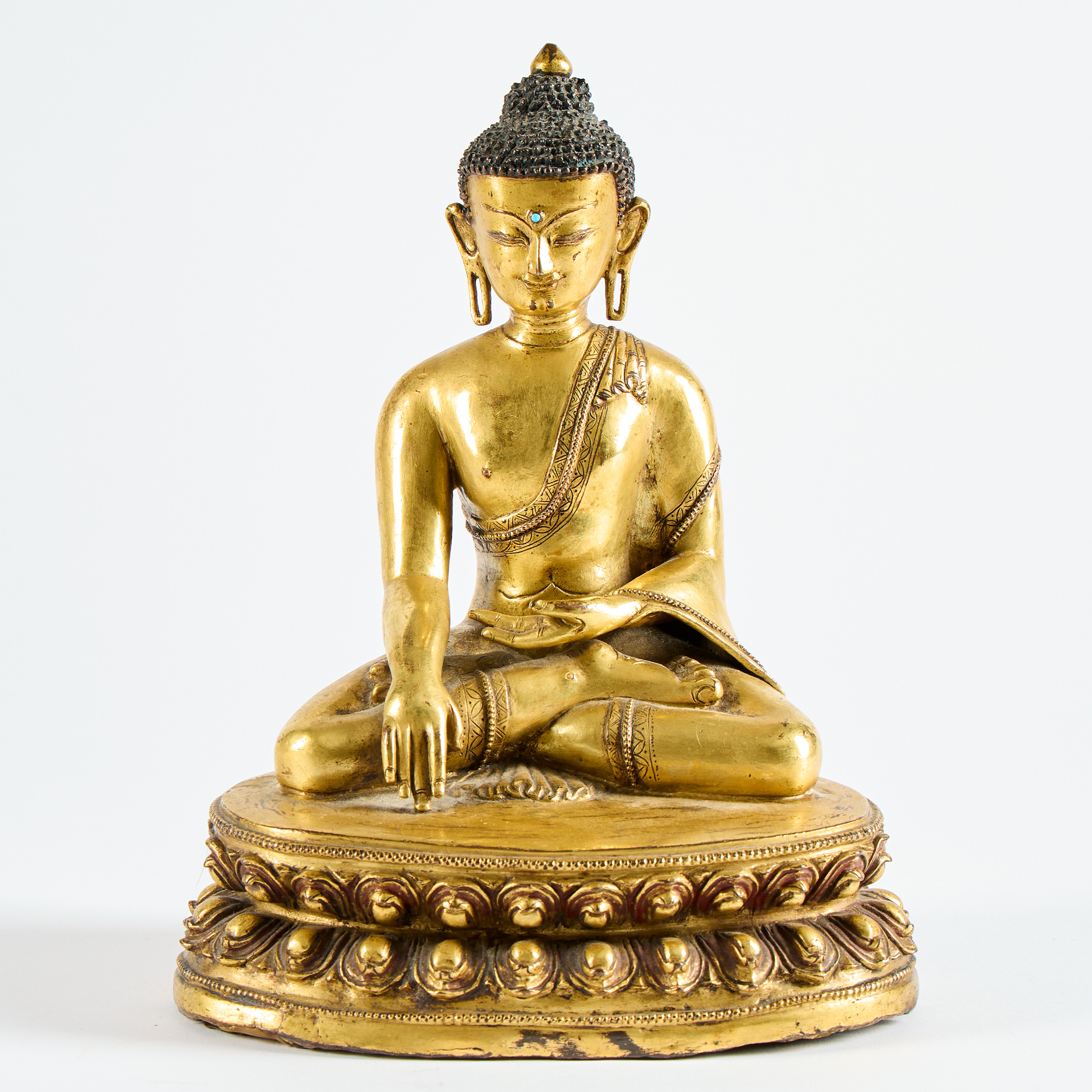 A Fine Tibetan Gilt-Copper Alloy Figure of Shakyamuni Buddha.