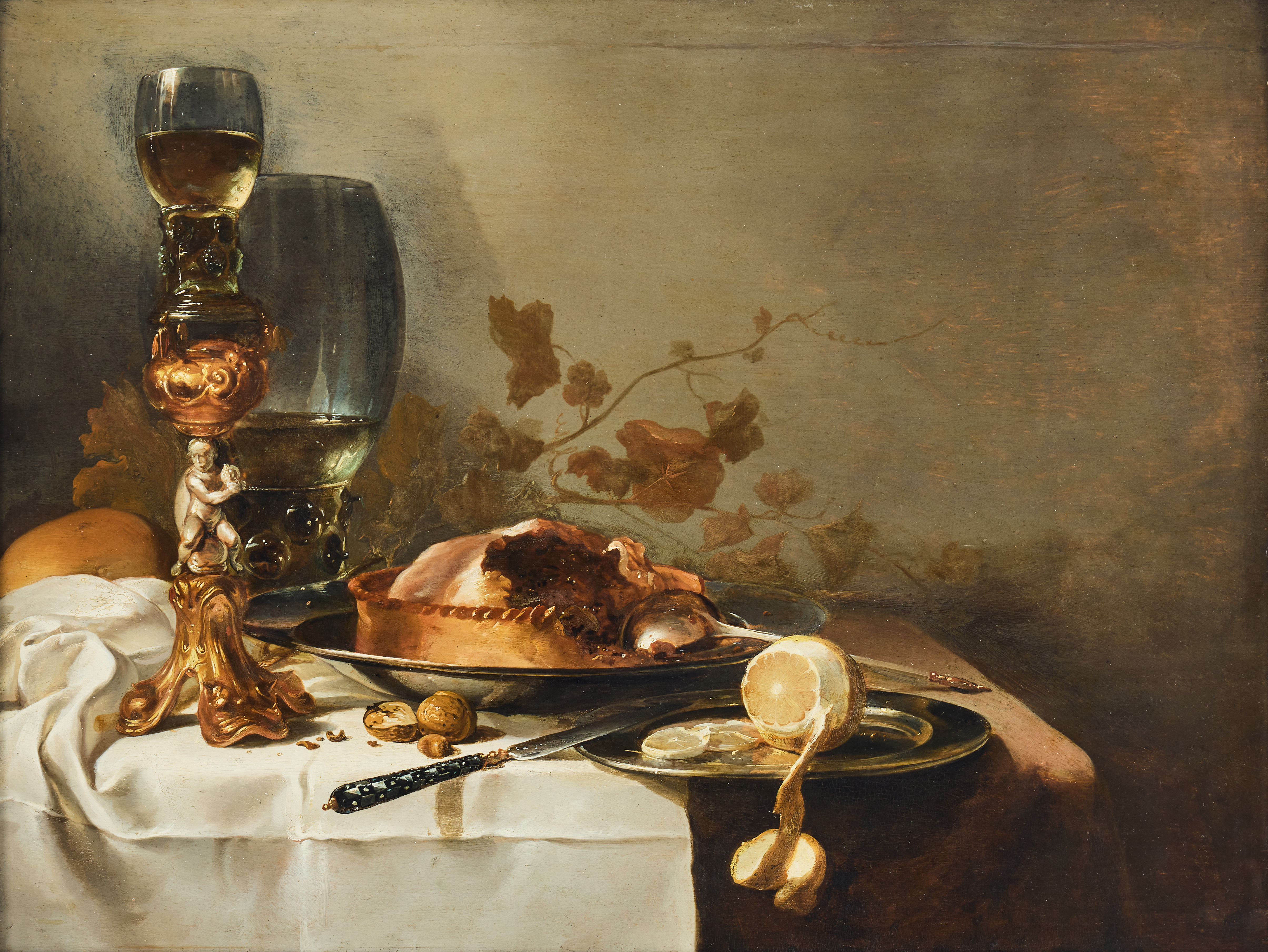 DUTCH SCHOOL, 17TH CENTURY. Follower of Pieter Claesz. Still life with a fruit pie, a silver-gilt Bekerschroef, a rummer and a lemon on a draped white tablecloth.