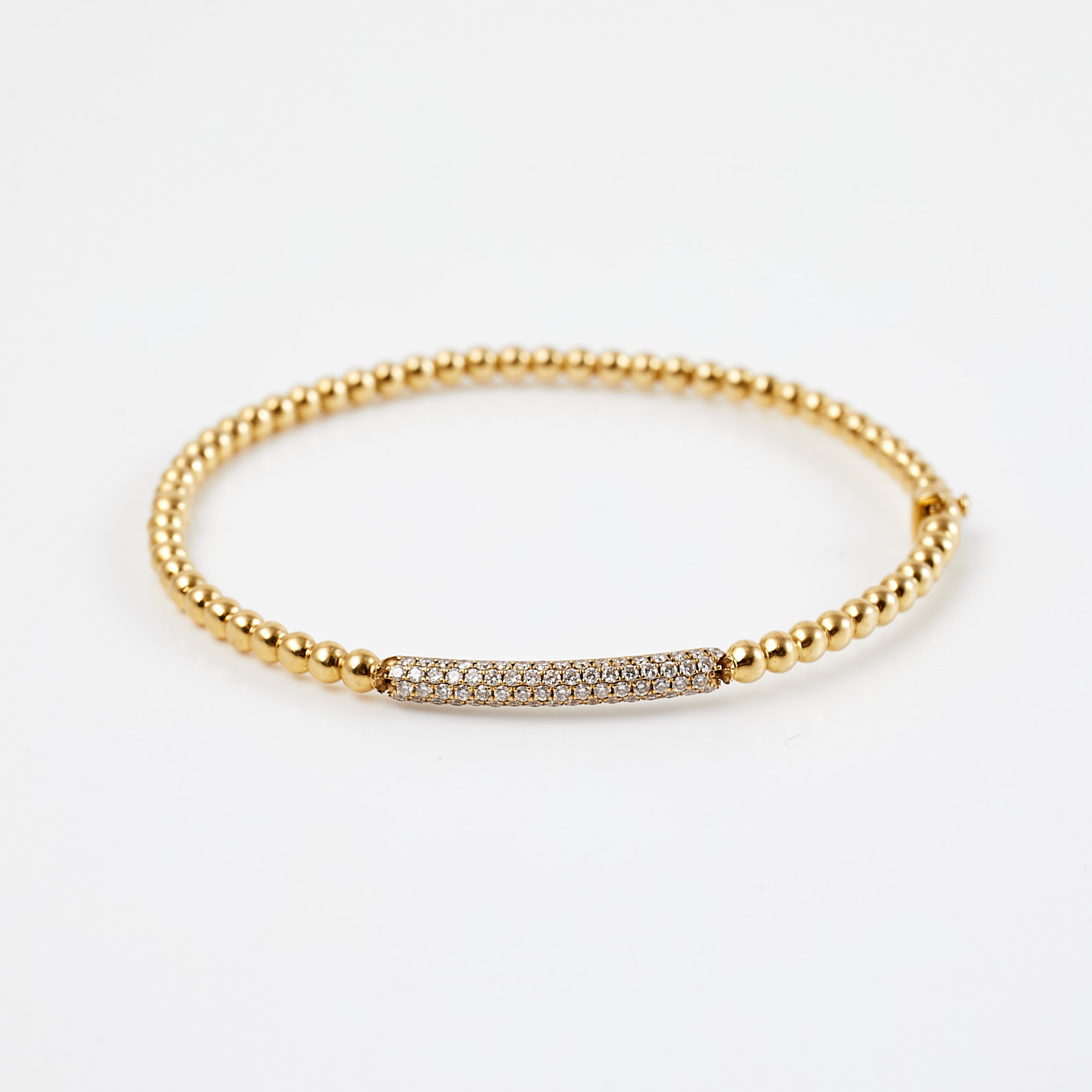 ARMRING, 18 k guld, 83 briljantslipade diamanter, totalt ca 0,83 ct, kulformad dekor.