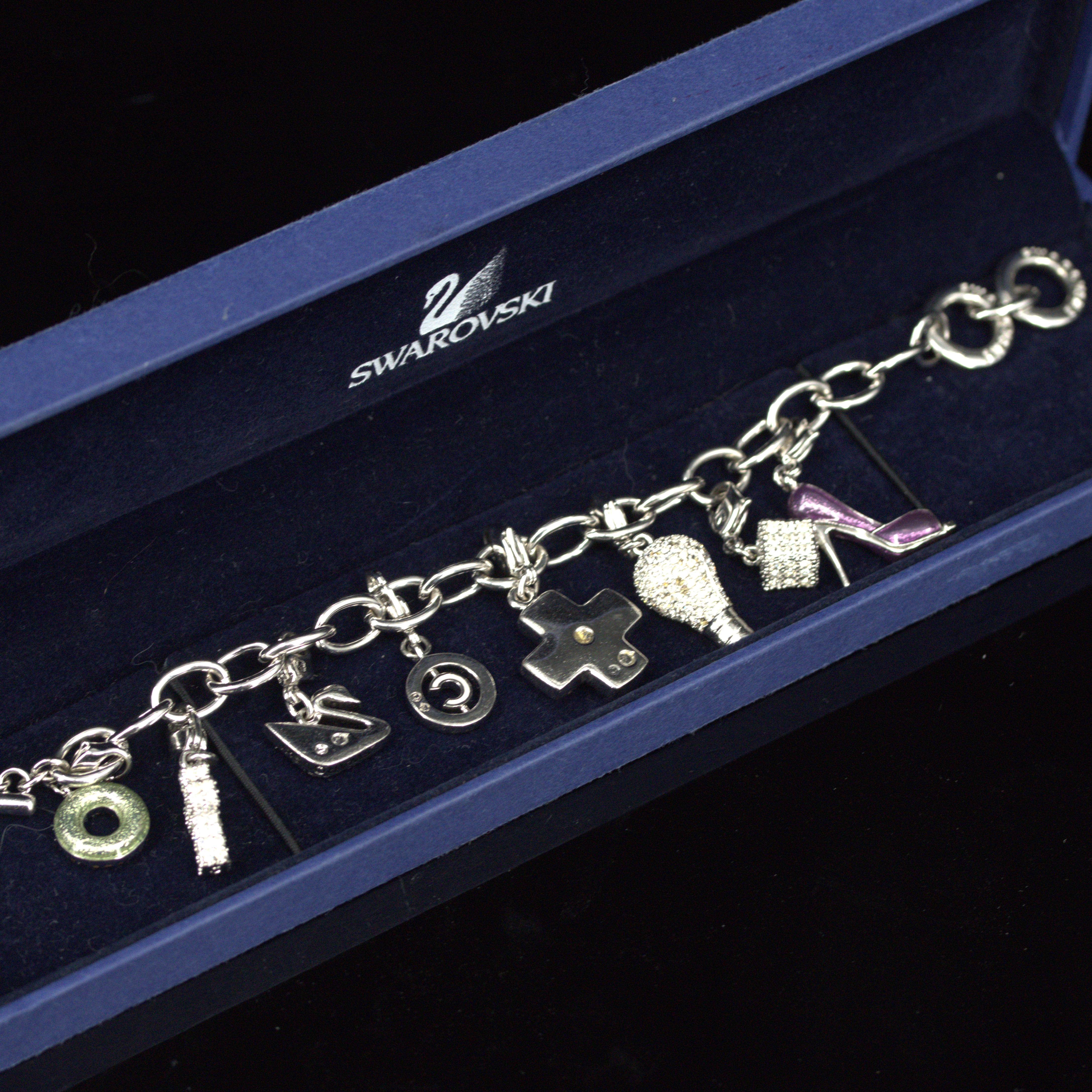 ARMBAND med åtta berlocker, metall och strass, bygellås, Swarovski.