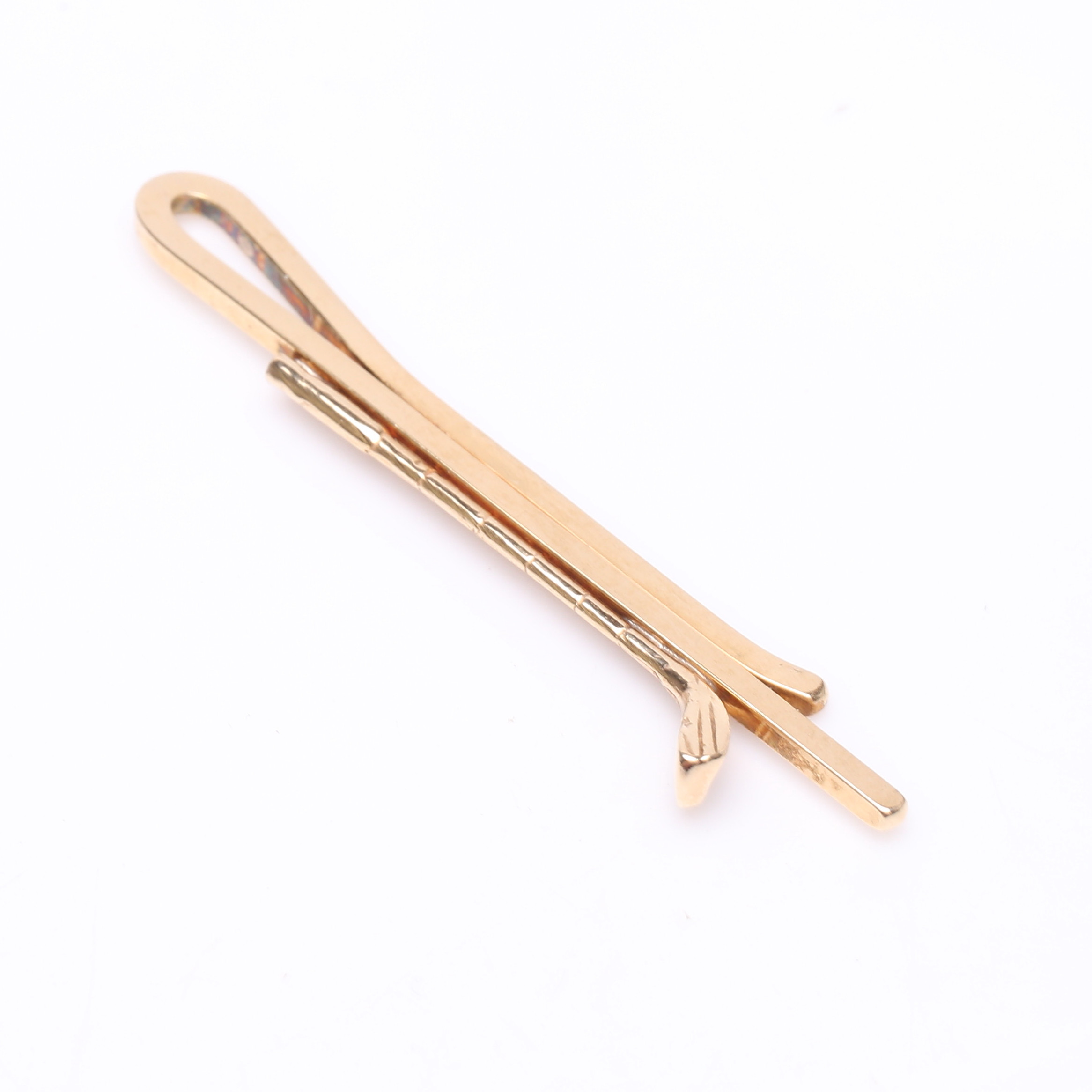 SLIPSNÅL, förgyllt silver, i form av golfklubbor.