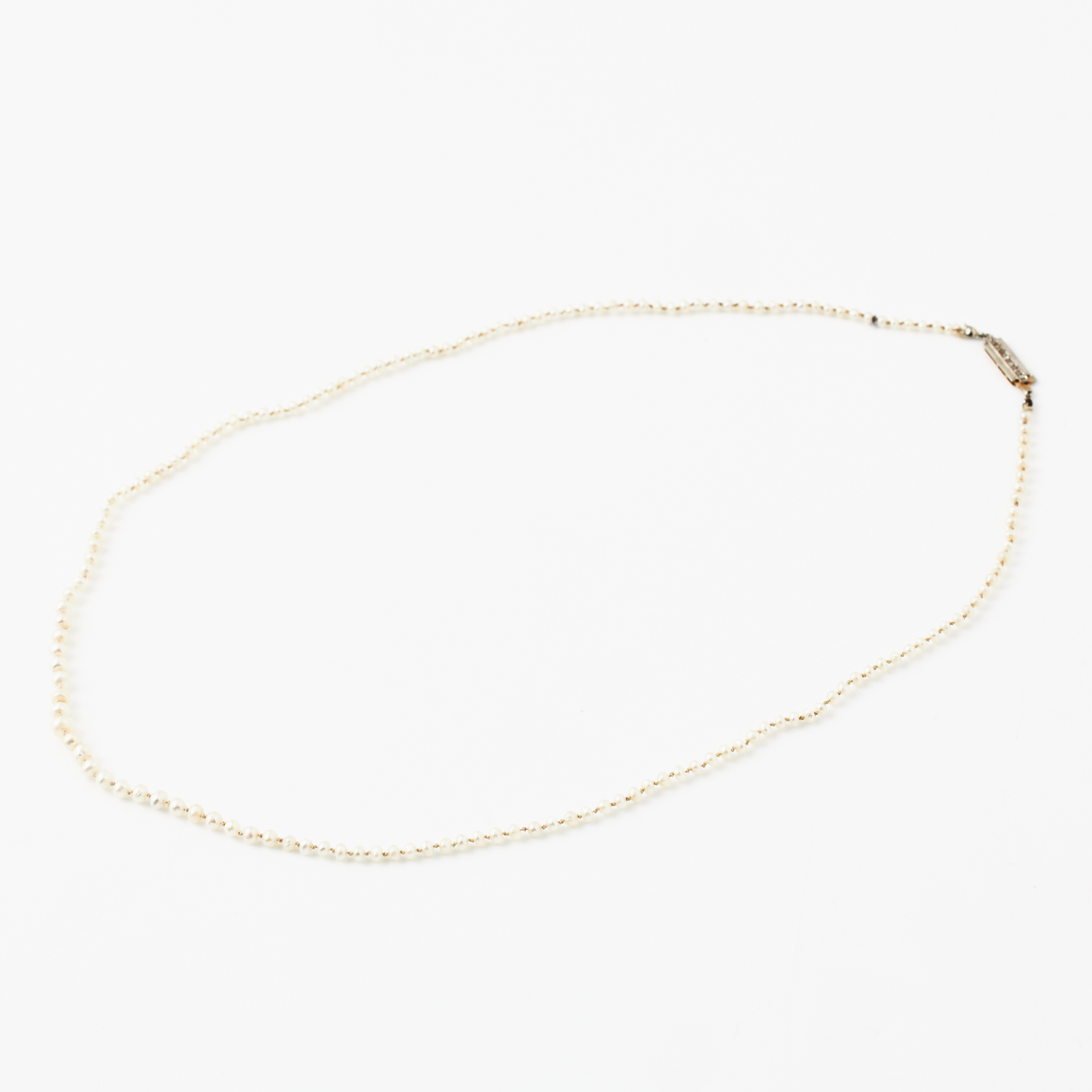 COLLIER, doserat, möjligen orientpärlor, rektangulärt lås, 18 k guld, dekor med 7 små rosenslipade diamanter i platinamontering, Juvelerare AB J Petterssons Eftr., Stockholm 1938.