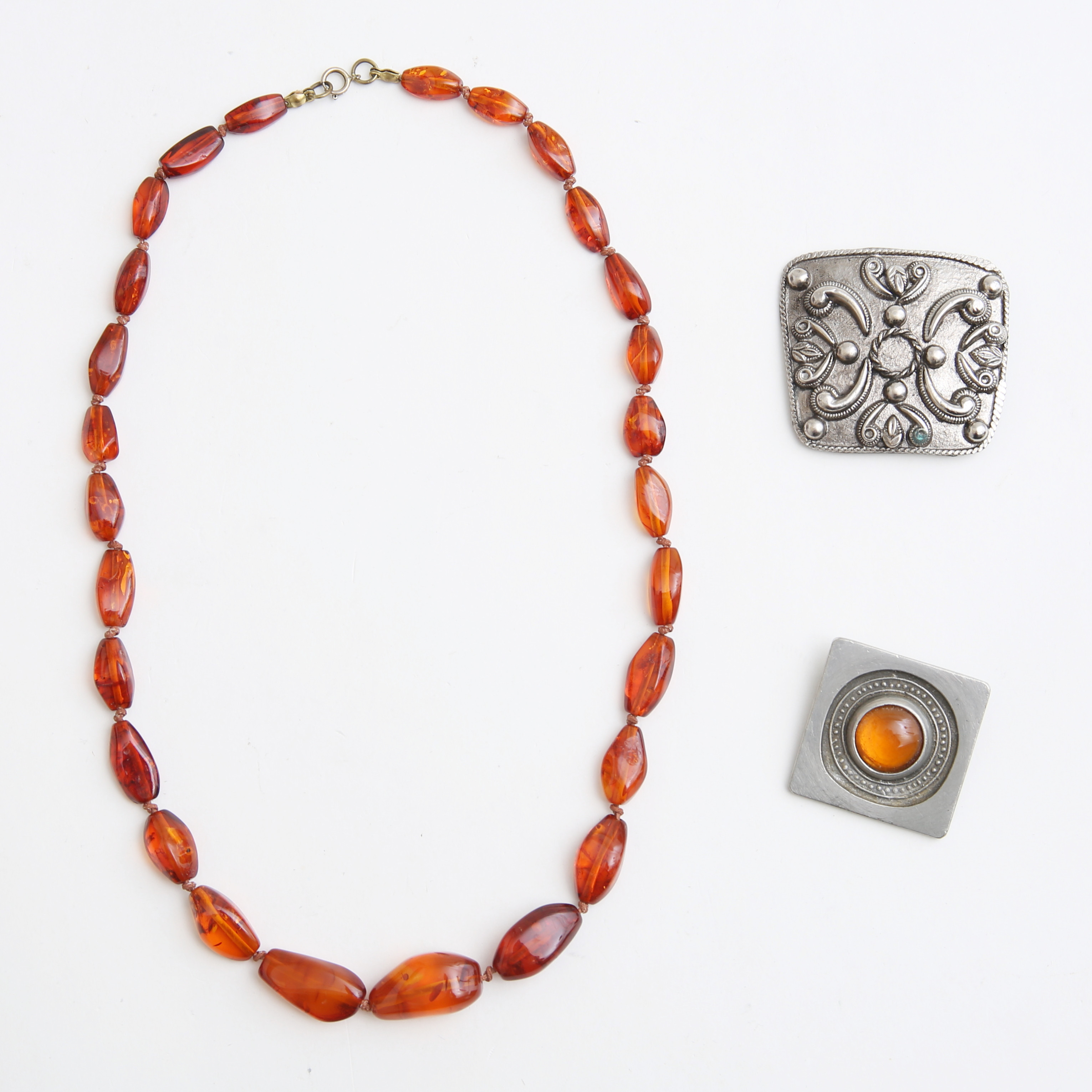 BÄRNSTENSHALSBAND samt BROSCHER, 1900-tal.