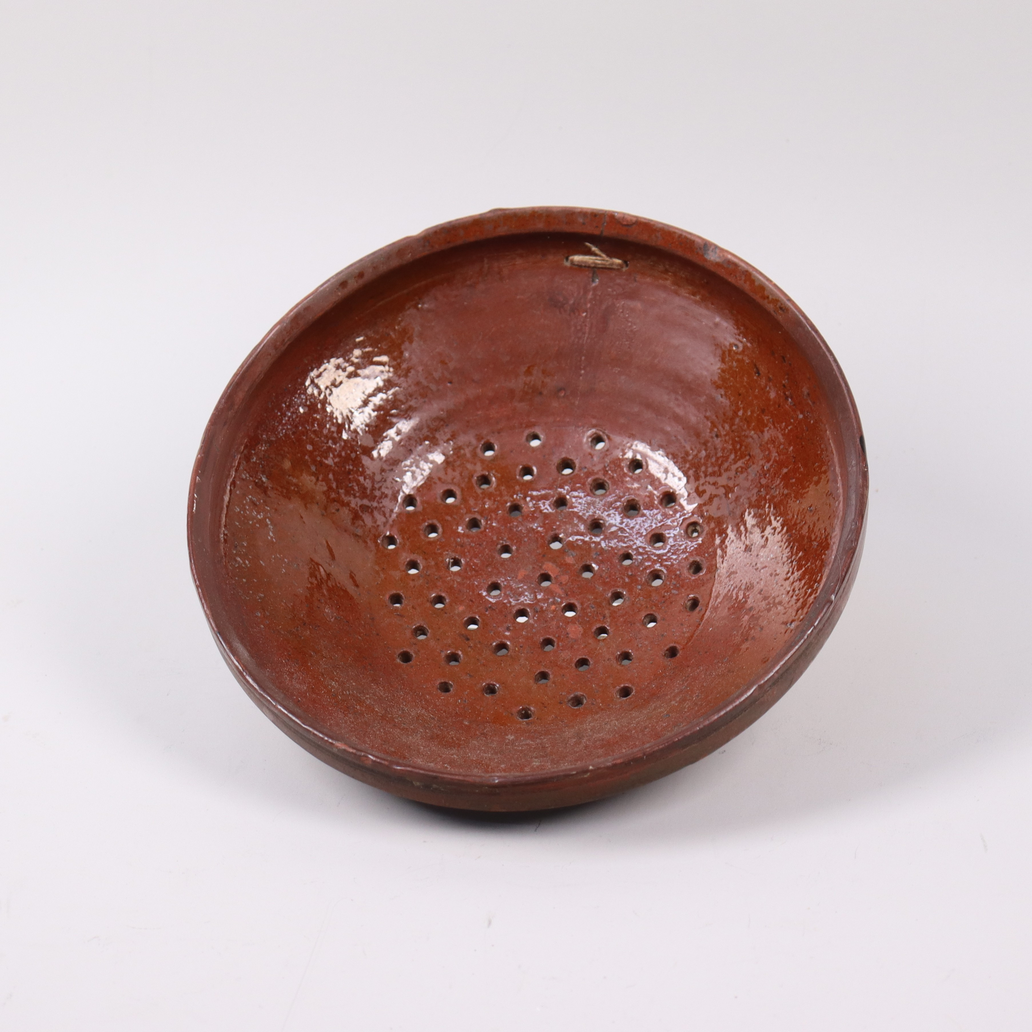 FRANS BERNHARD STENBÄCK (1858-1921), Trelleborg, såll i ställvis glaserat lergods, 1800-tal.