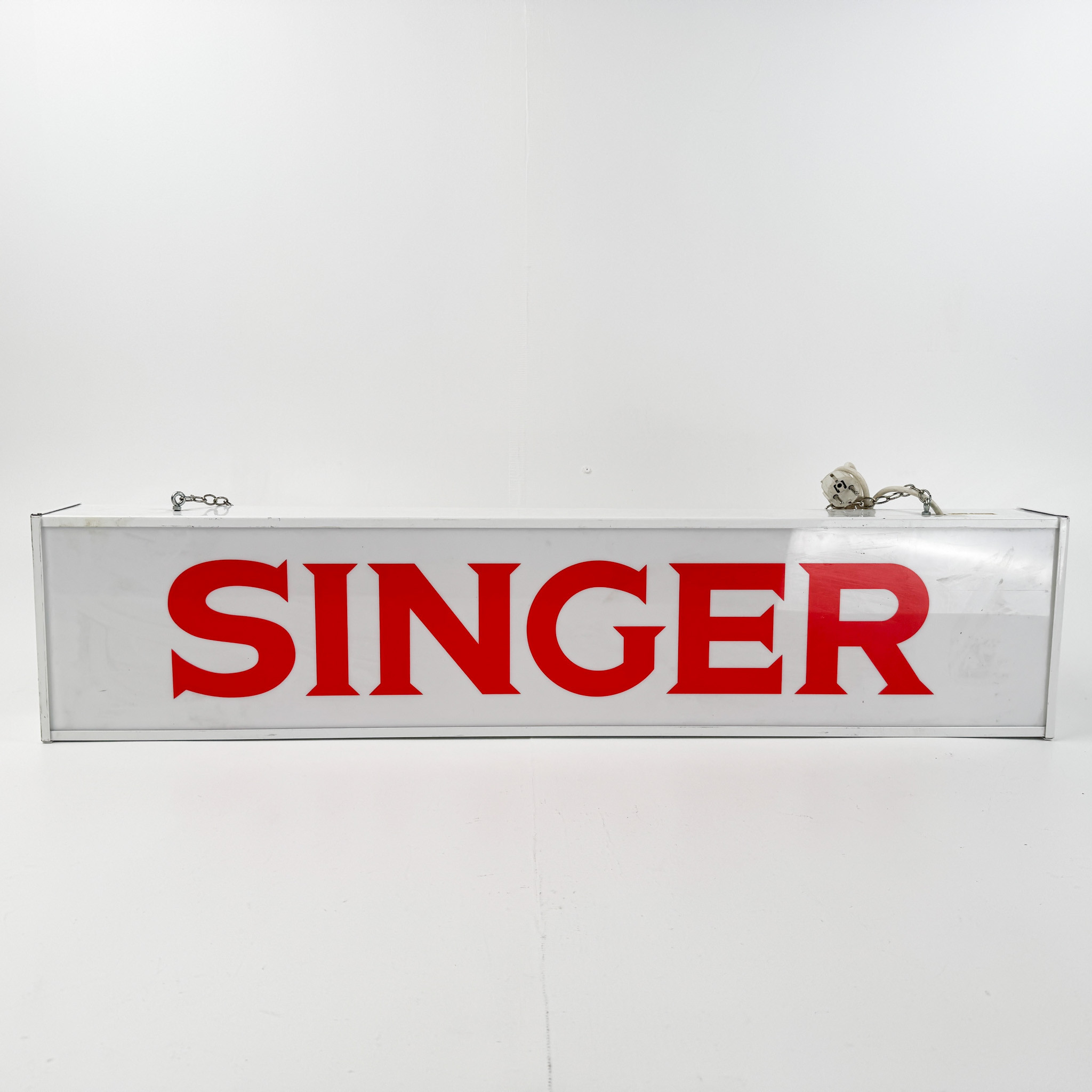 SINGER, ljusskylt, 1900-talets senare del.