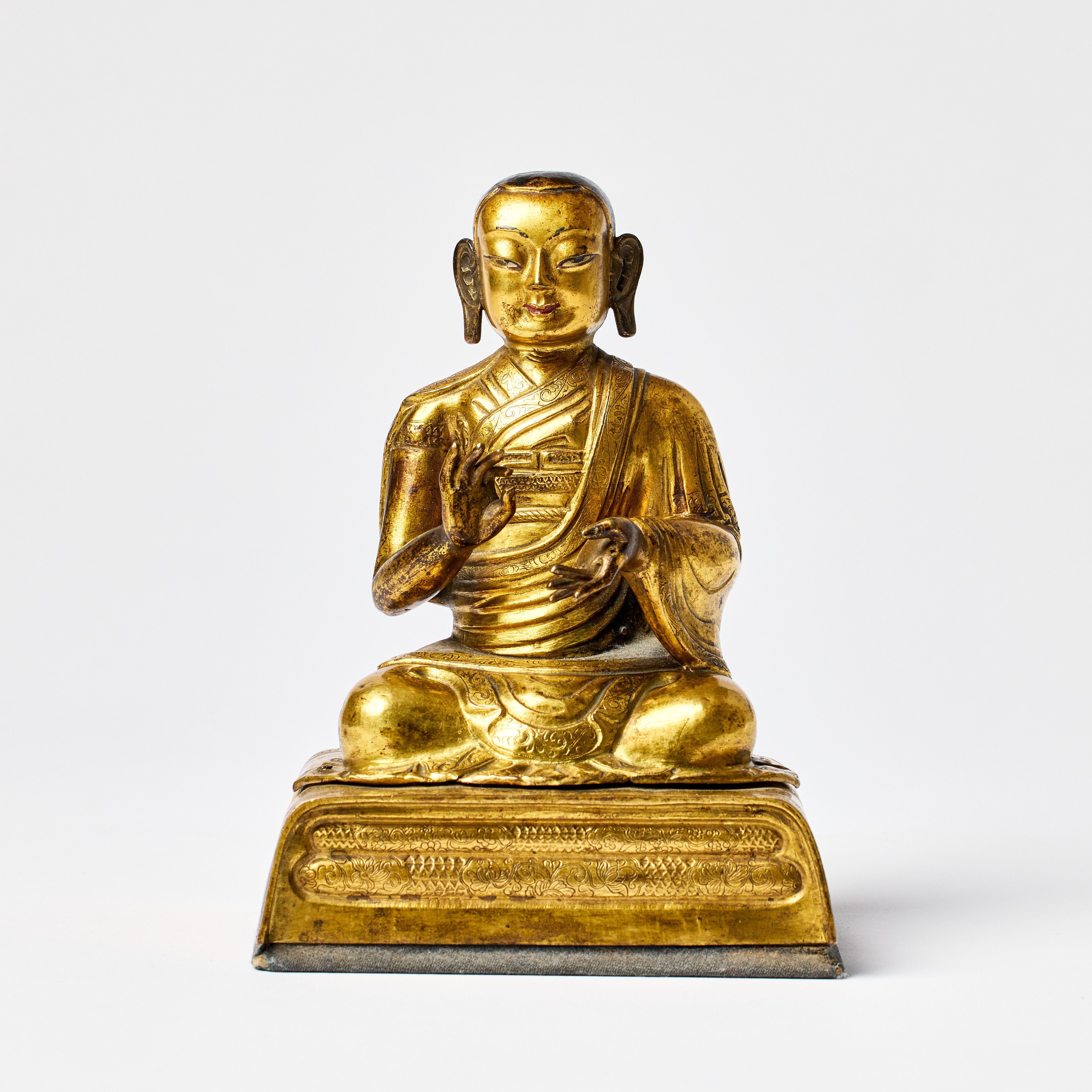 A Tibeto-Chinese Gilt Brass/Copper Repoussé Figure of a Lama or a Lohan.