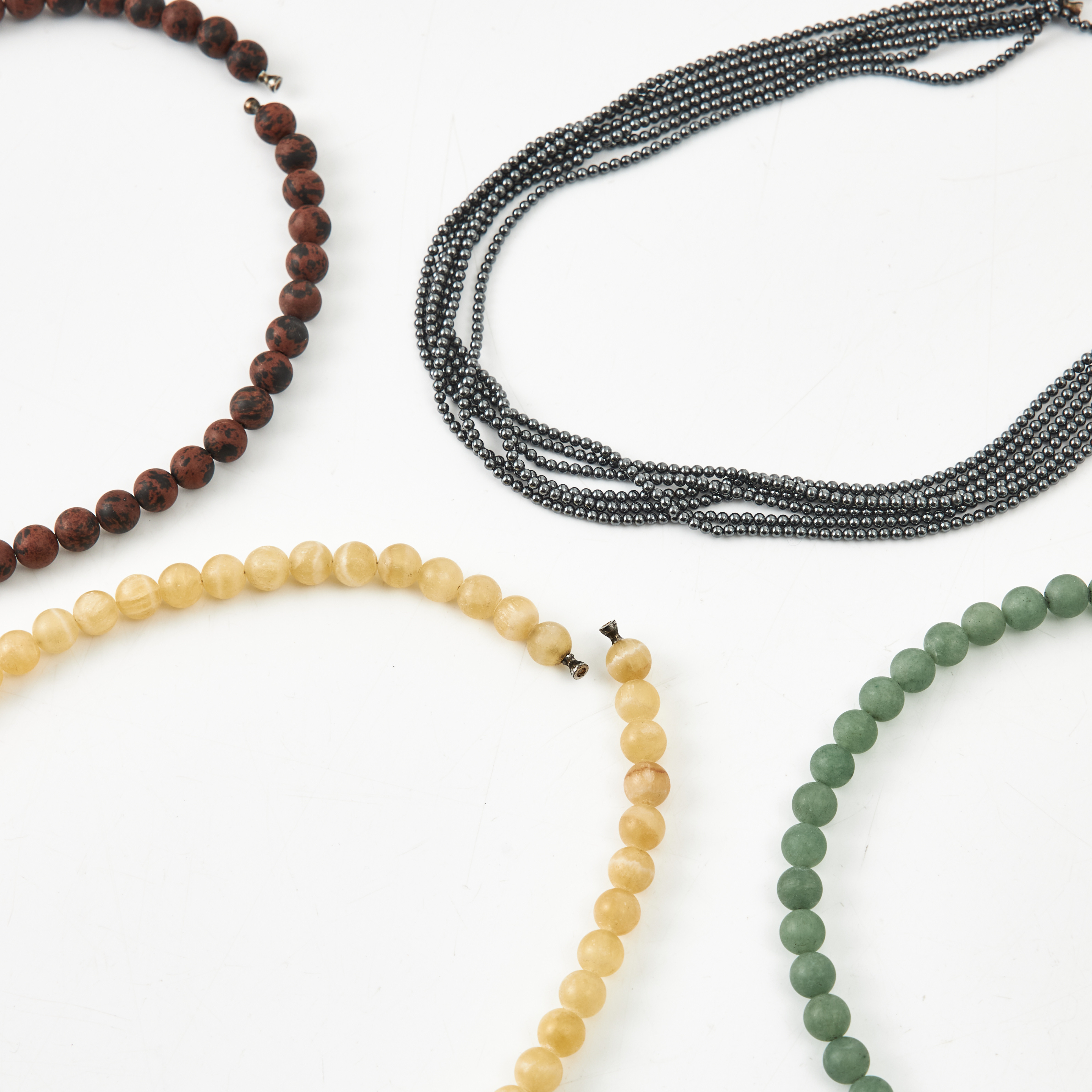 OLE LYNGGAARD, collier, 4 st., stenkulor, varav ett 9-radigt med hematitkulor, avslut med klassiska dobbar.