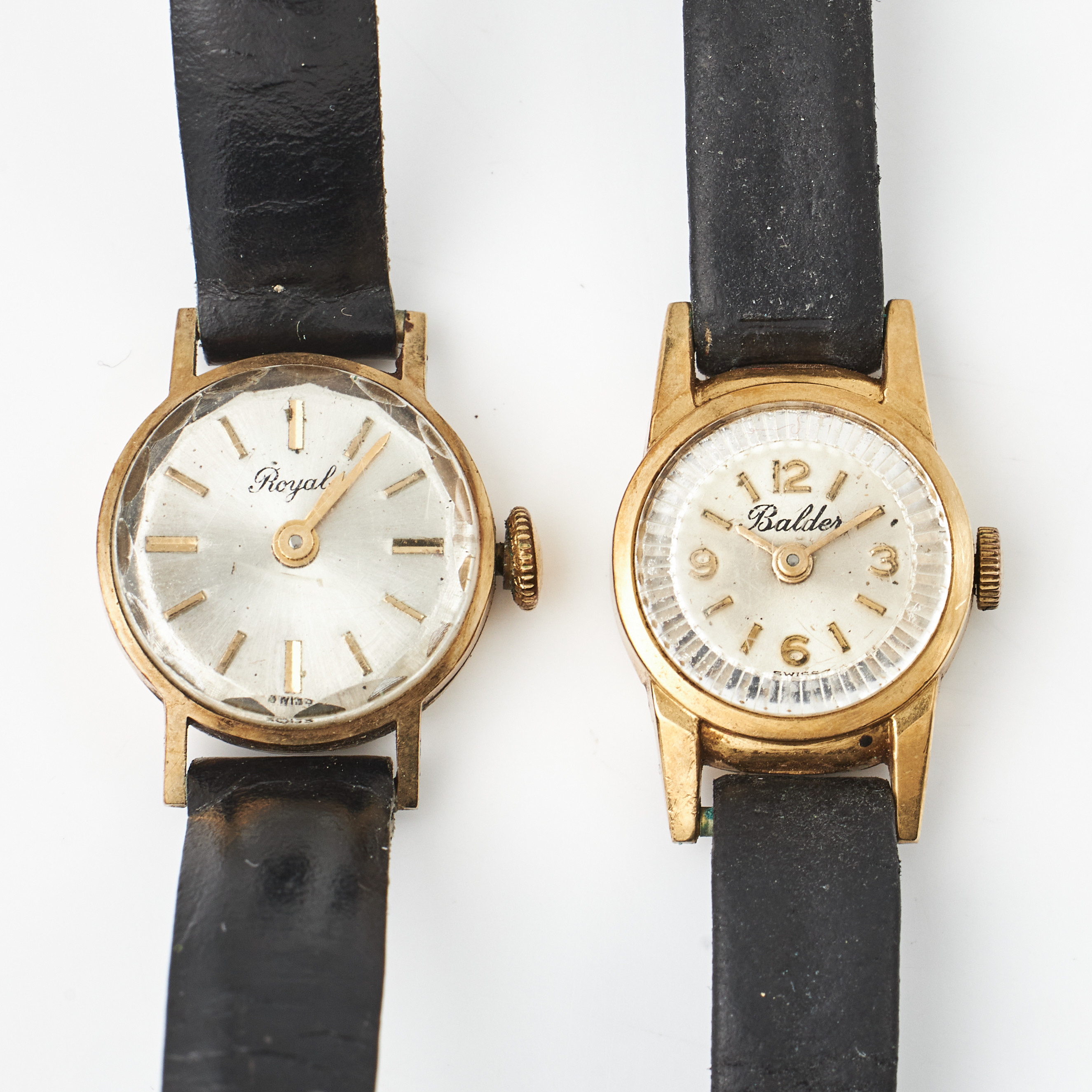 ARMBANDSUR, 2 st., 14 resp. 18 k guld, Royal resp. Balder, manuella, plexiglas, svarta läderband.