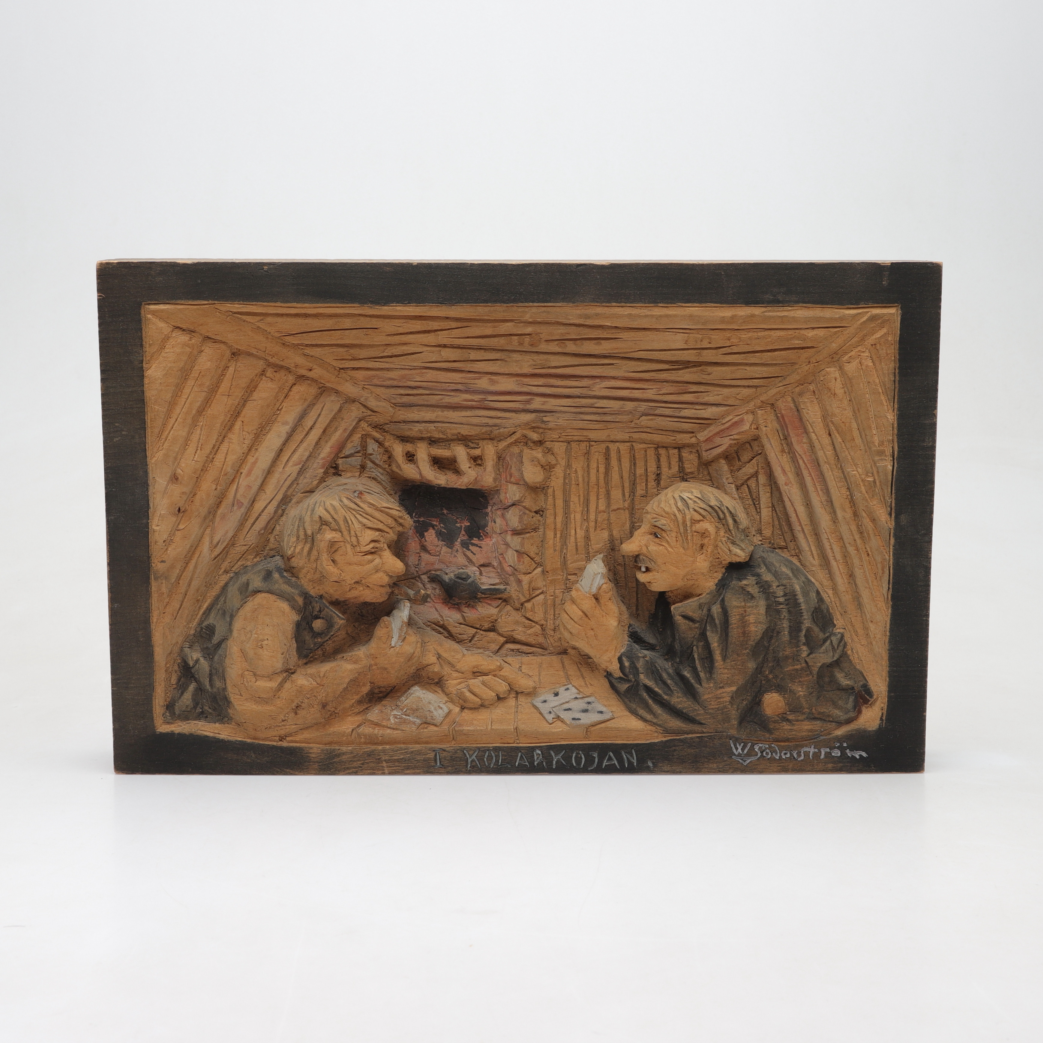 OIDENTIFIERAD KONSTNÄR, Trärelief, " I kolakojan", signerad W Söderström, daterad 1942.