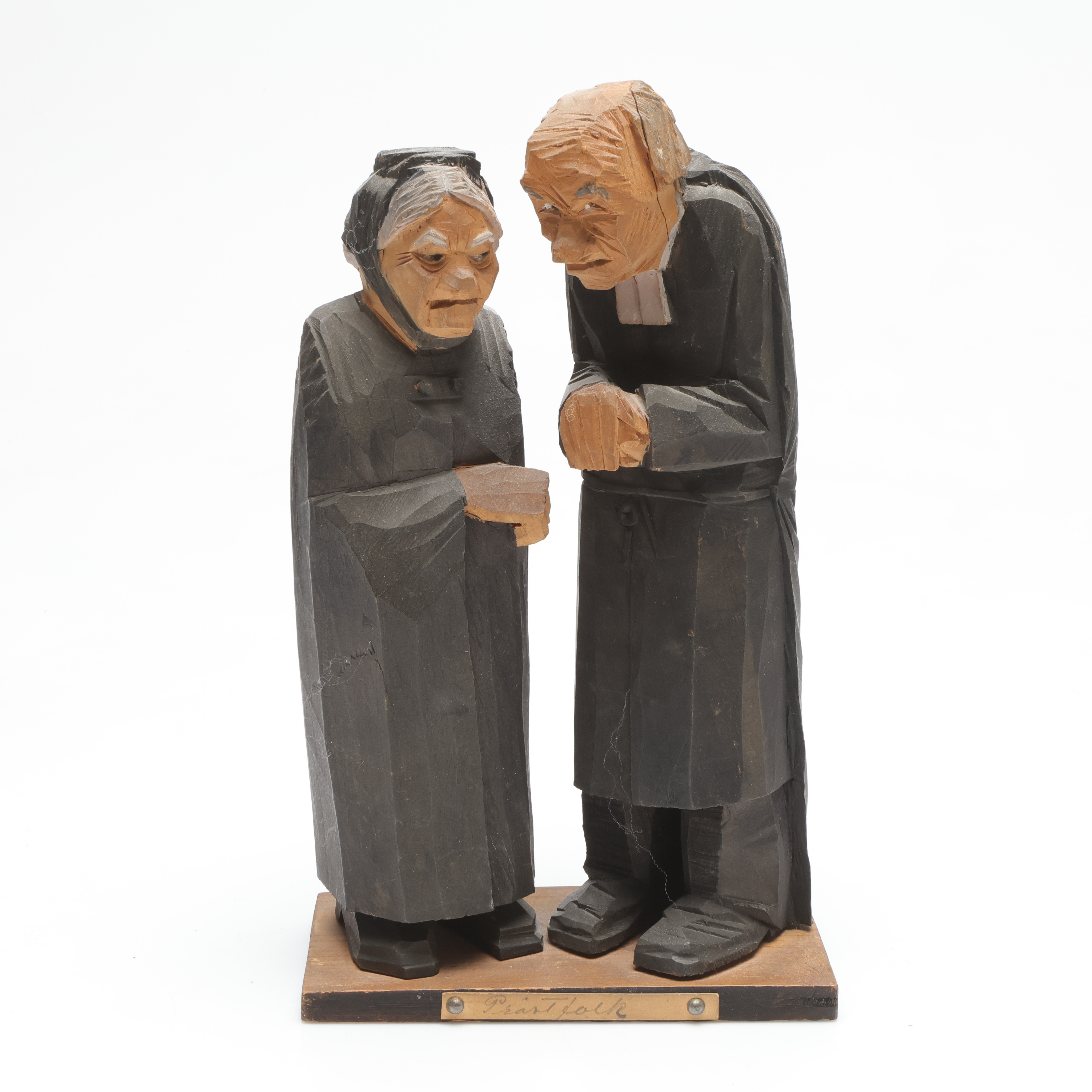 CARL JOHAN TRYGG. skulptur, "Prästfolk", snidat trä, signerad och daterad 1917.