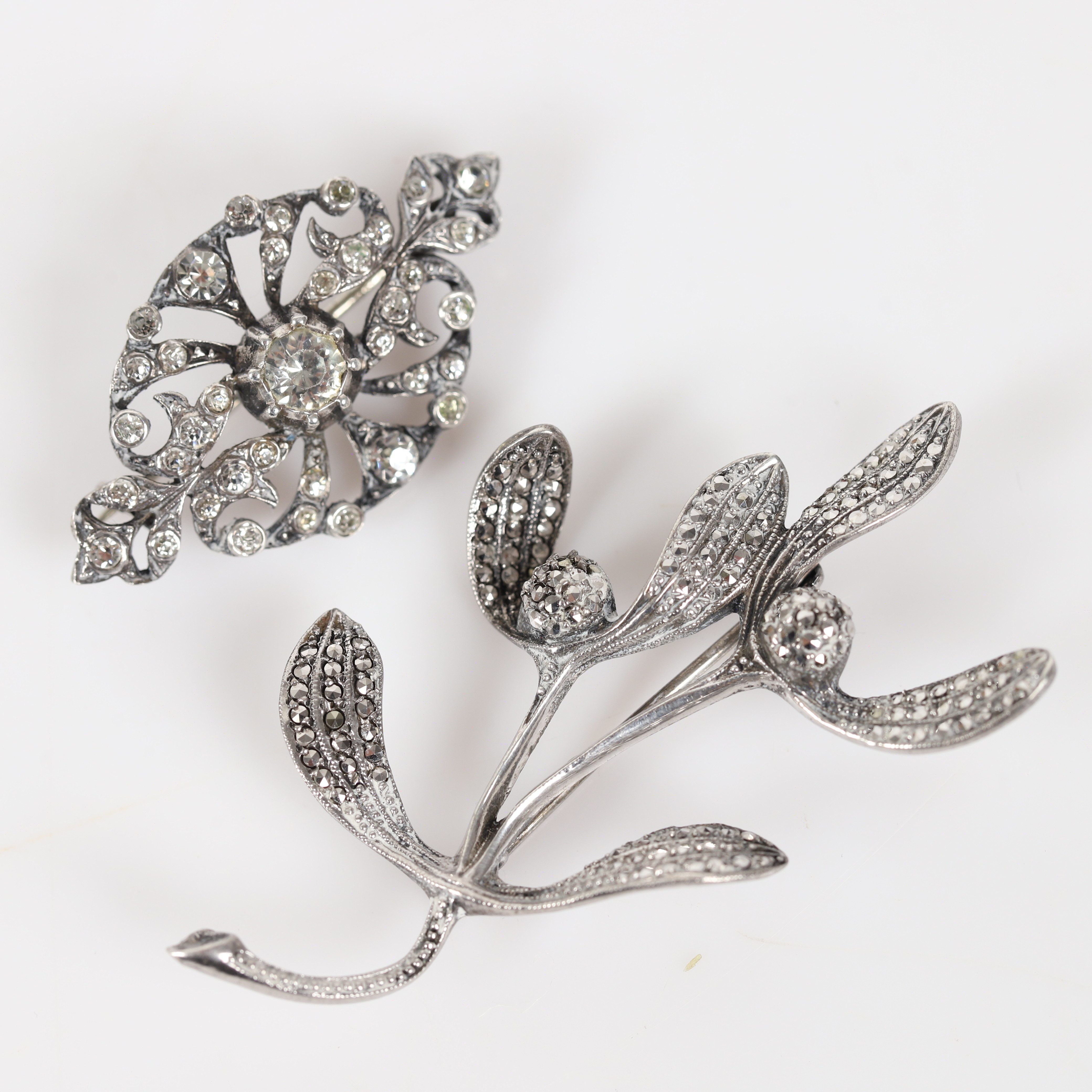BROSCHER, 2 stycken, silver med markasiter och fasettslipade stenar.