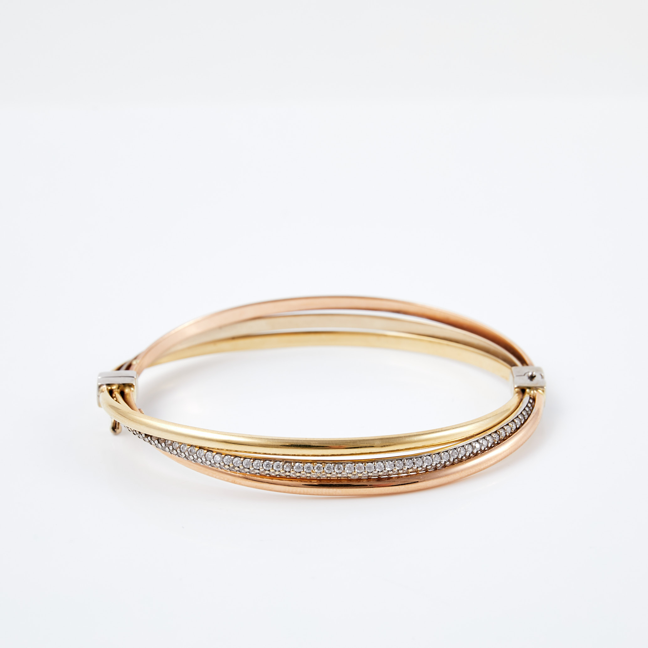 ARMRING, 14 k vit- röd och roséguld, med fasettslipade cubic zirkoner.