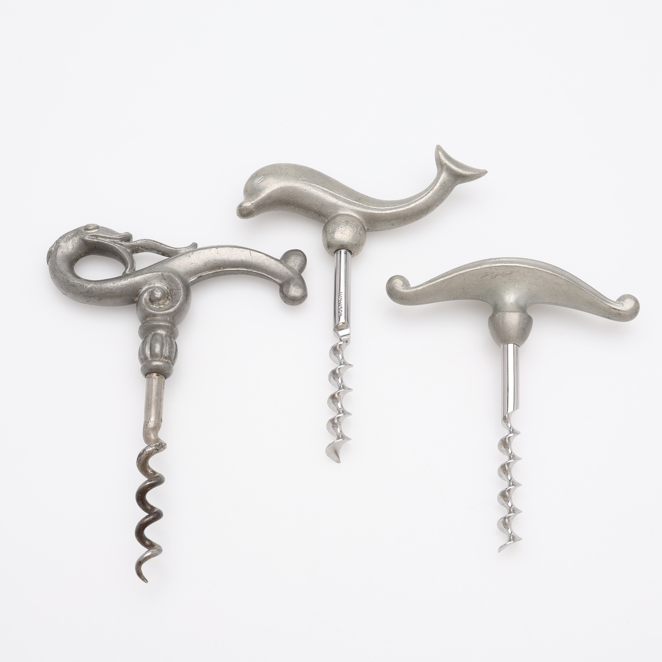 TRE STYCKEN KORKSKRUVAR FORMGIVNA AV JUST ANDERSEN, tenn och stål, 1920/30-tal.