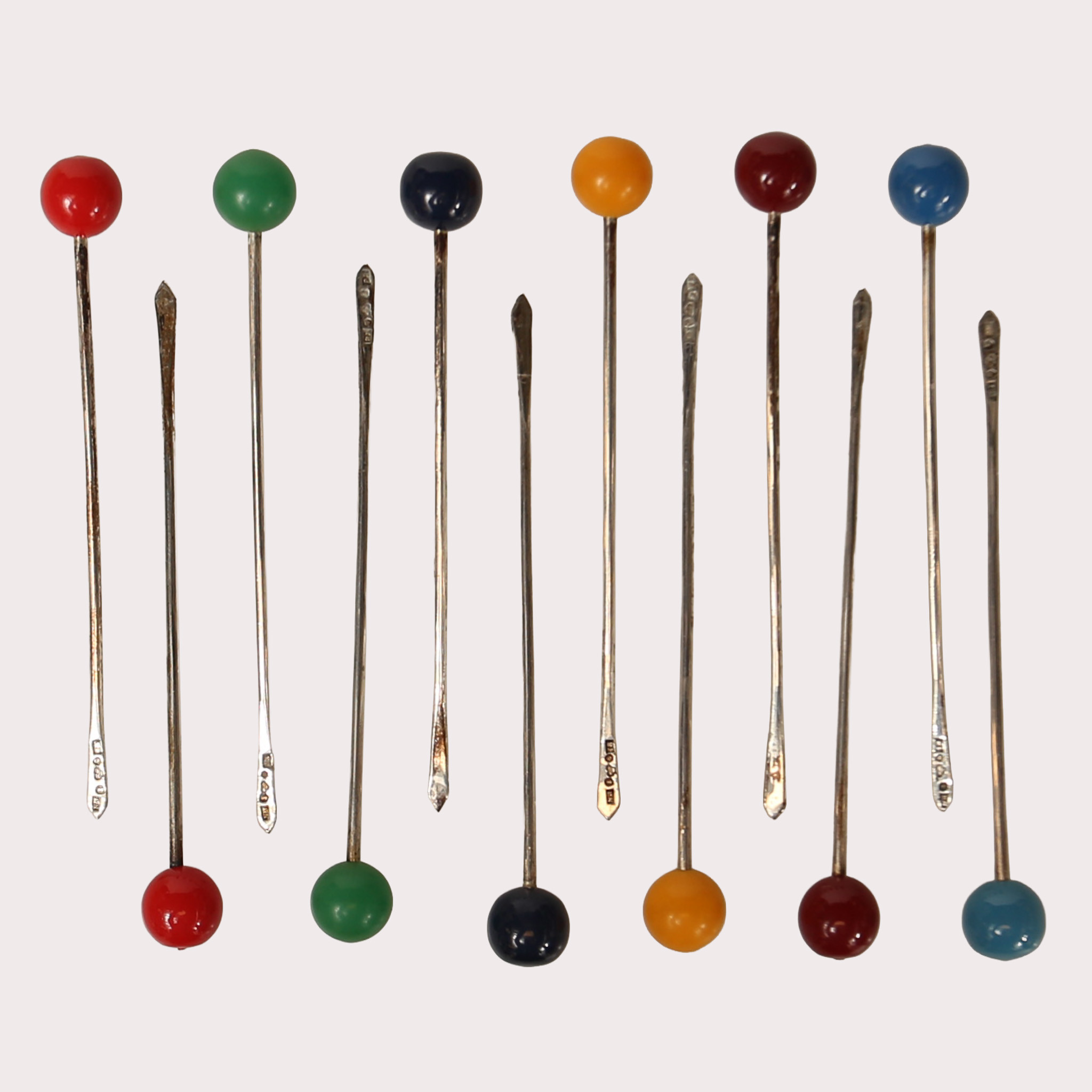 COCTAILPINNAR 12 st., silver, 830/1000, med olika färgade stenar. år 1935.