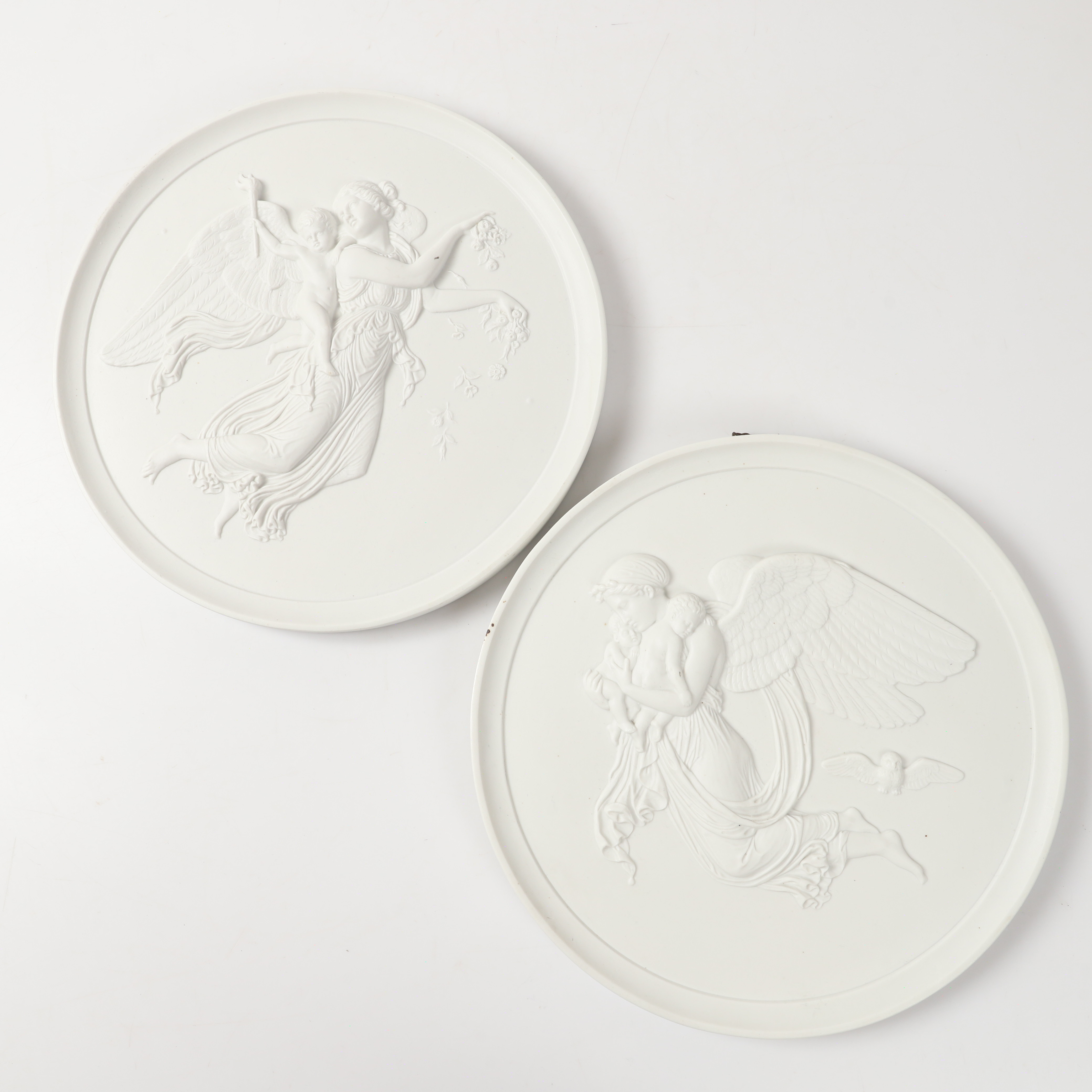 BERTEL THORVALDSEN. Väggplaketter, 2 stycken, "Natt & Dag", biskviporslin, Royal Copenhagen, Danmark.