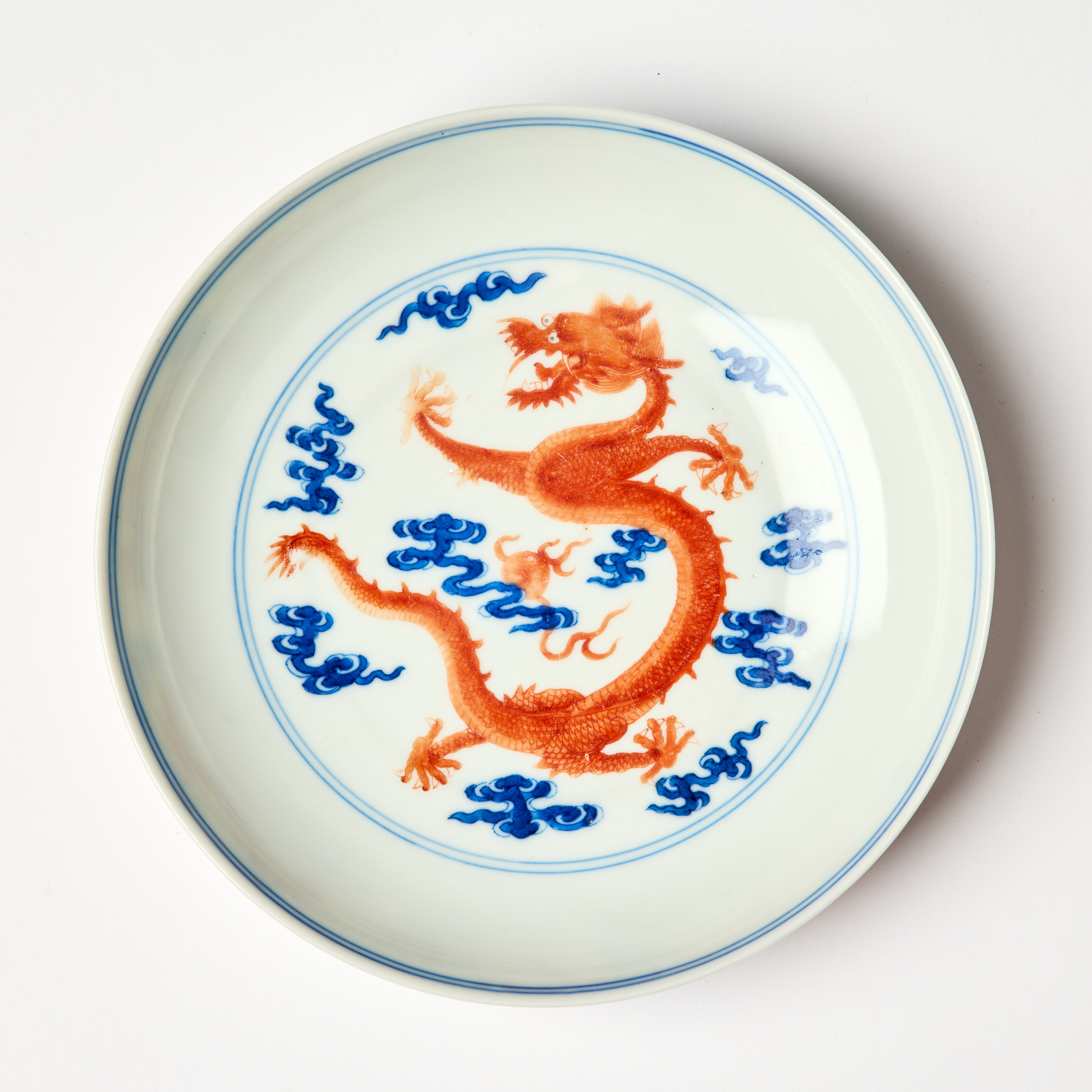 A Chinese Iron-Red and Underglaze Blue 'Dragons' Dish.