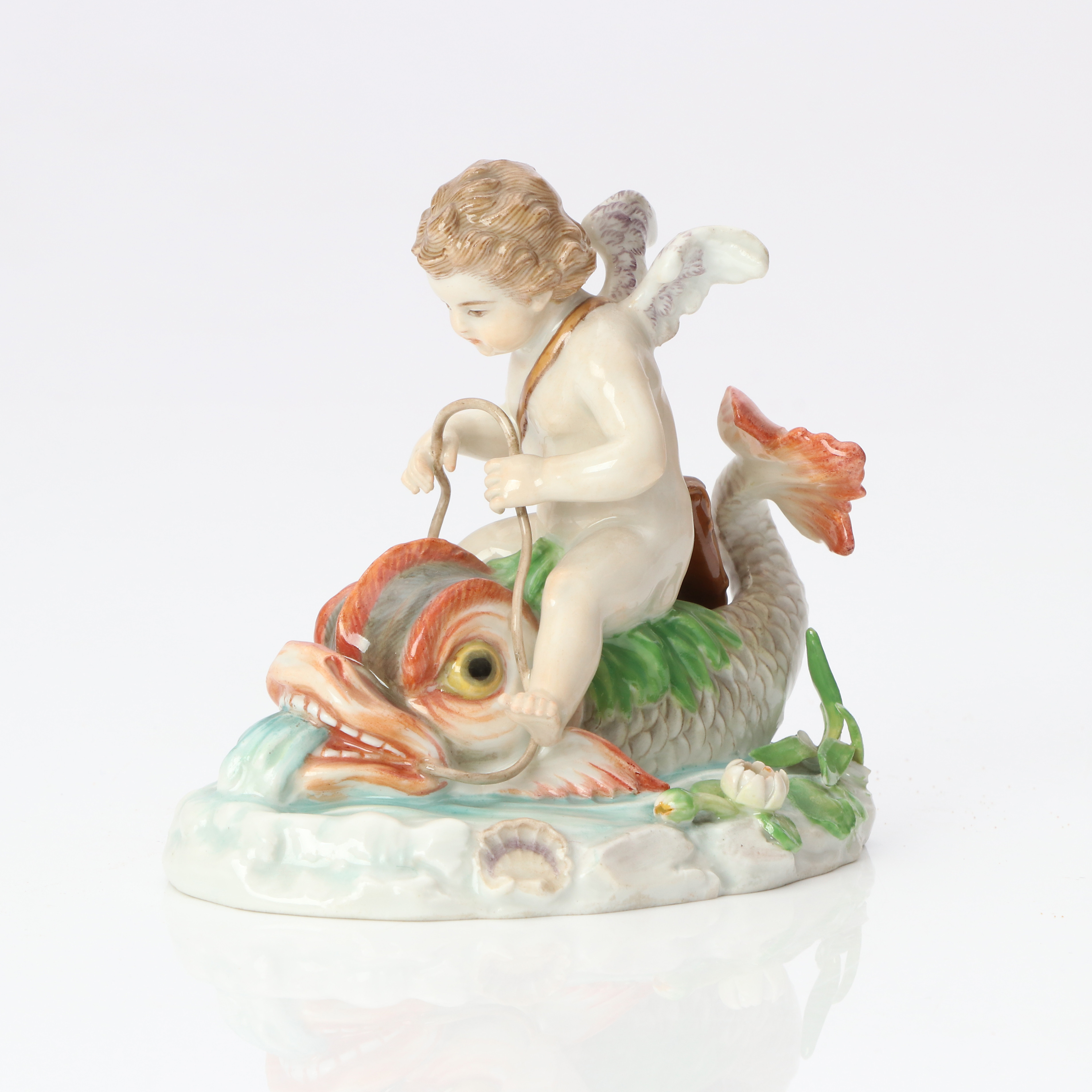 MEISSEN, FIGURIN. Porslin med polykrom dekor. Putto på delfin. Märkt undertill.