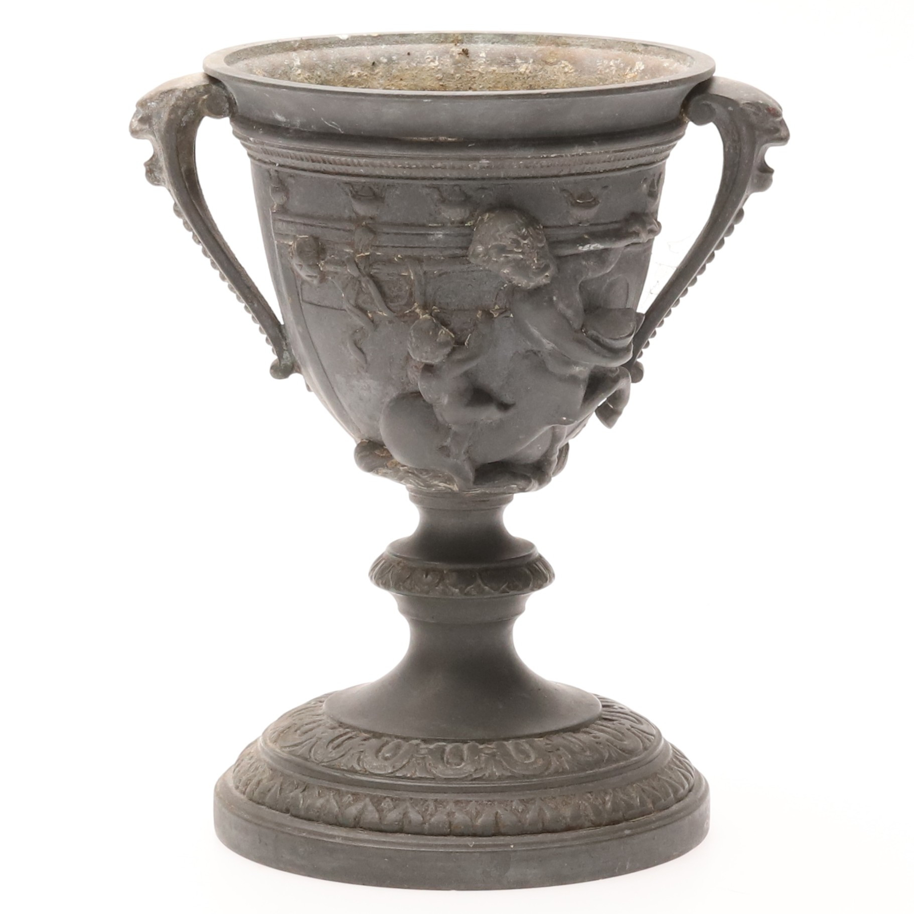 KALK. Patinerad vitmetall med figural reliefdekor.