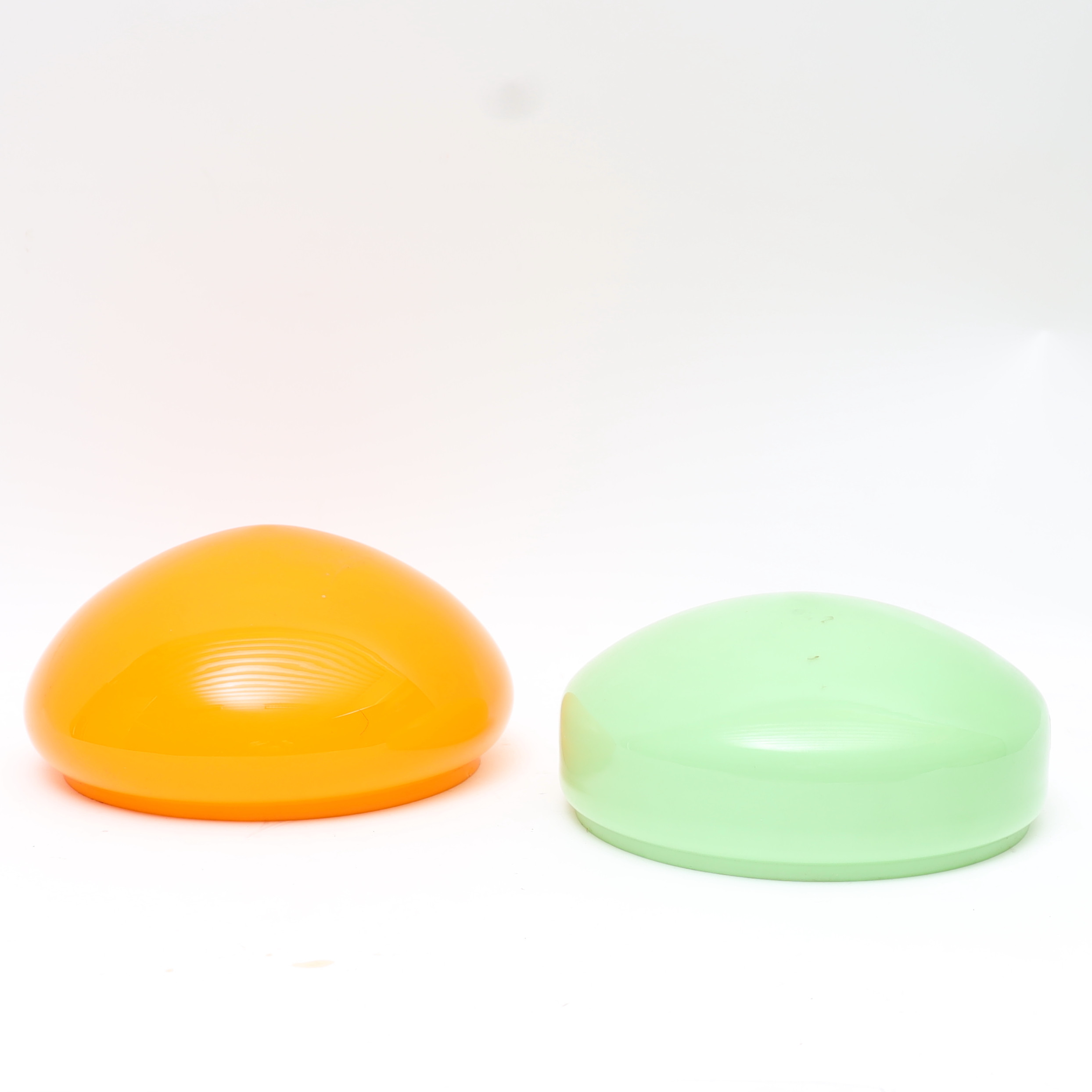 LAMPSKÄRMAR, 2st, tidigt 1900-tal, gröntonat respektive orangetonat glas.