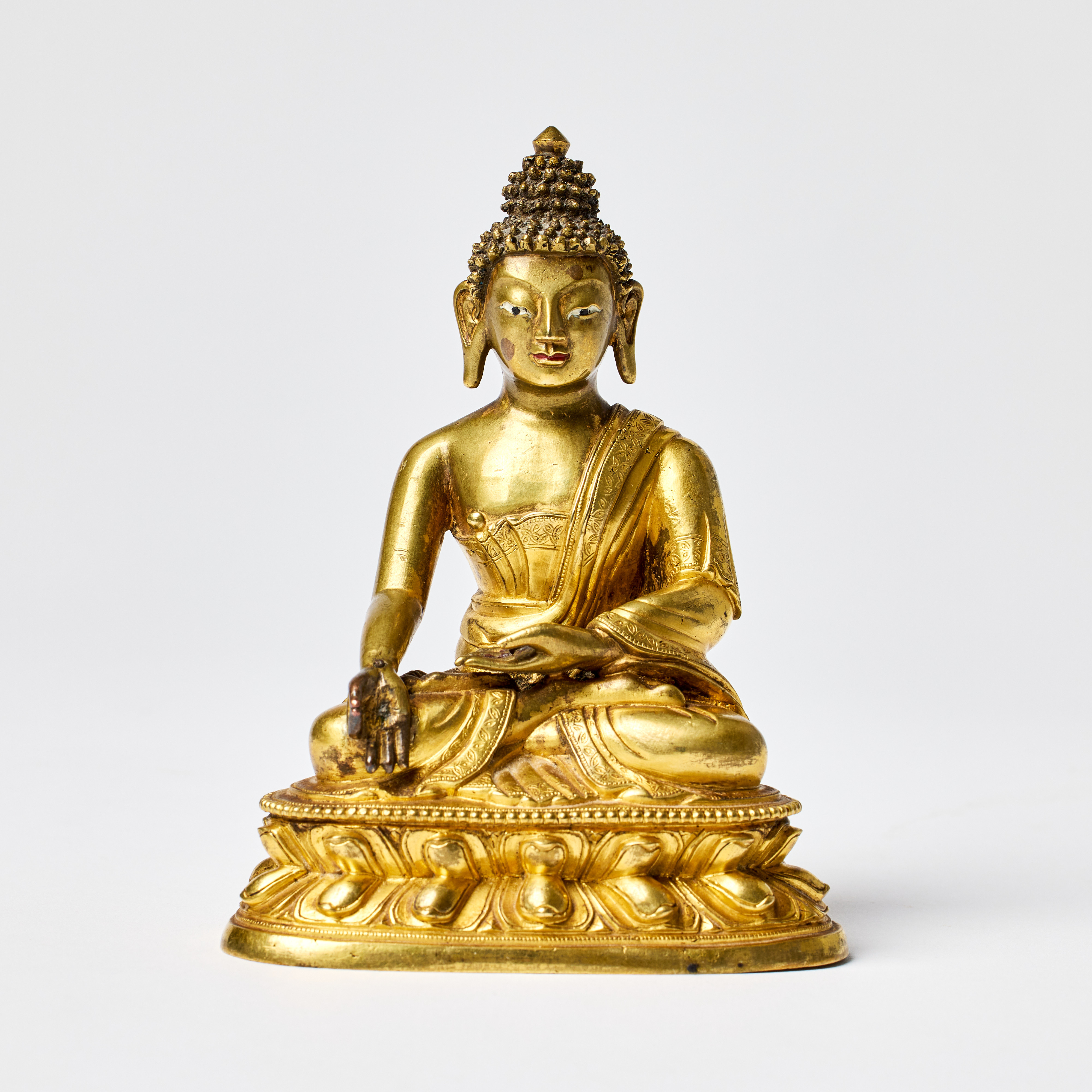 A Tibeto-Chinese Gilt-Bronze Figure of the Medicine Buddha, Bhaisajyaguru.
