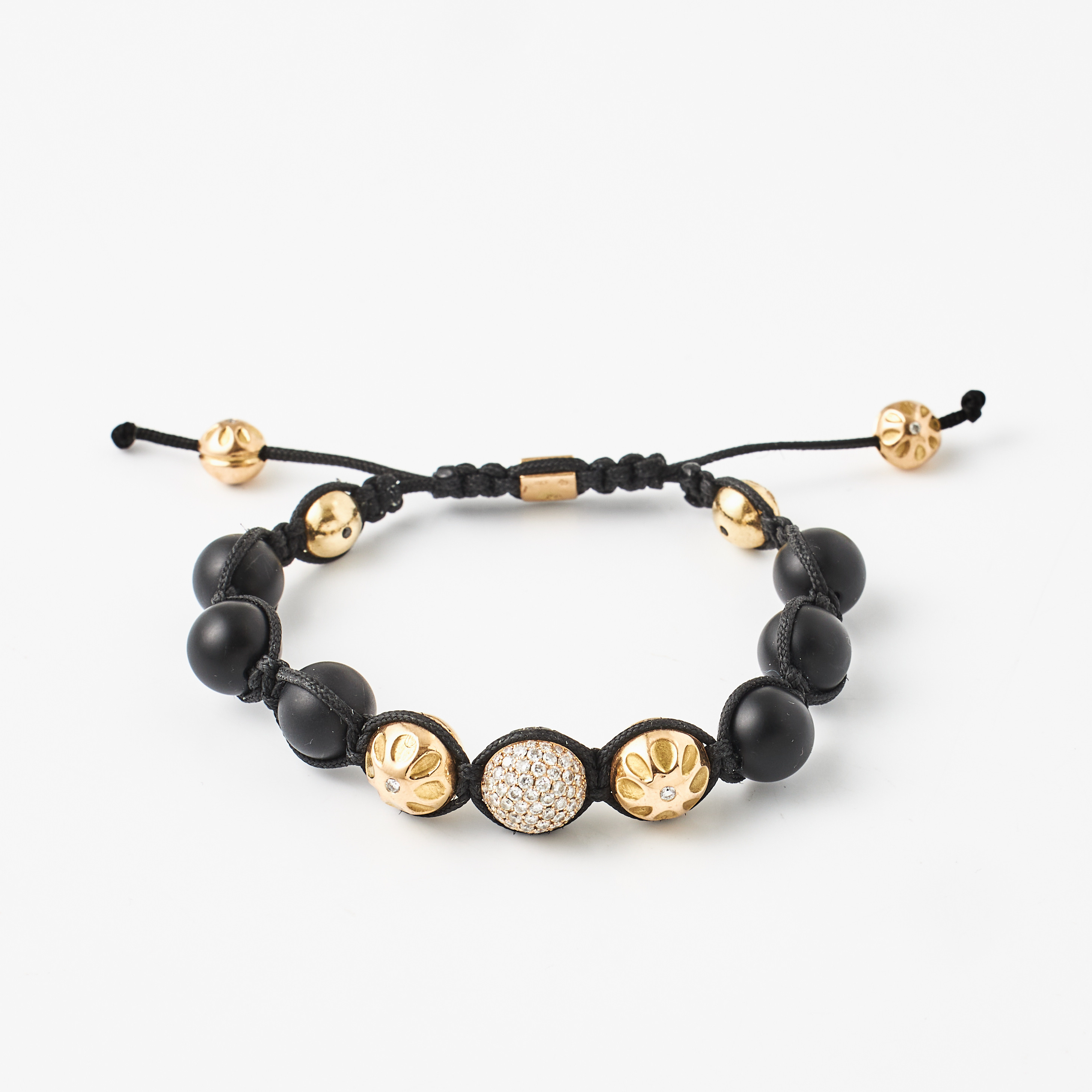 ARMBAND, 18K guld med svarta diamanter, diamanter och onyx.