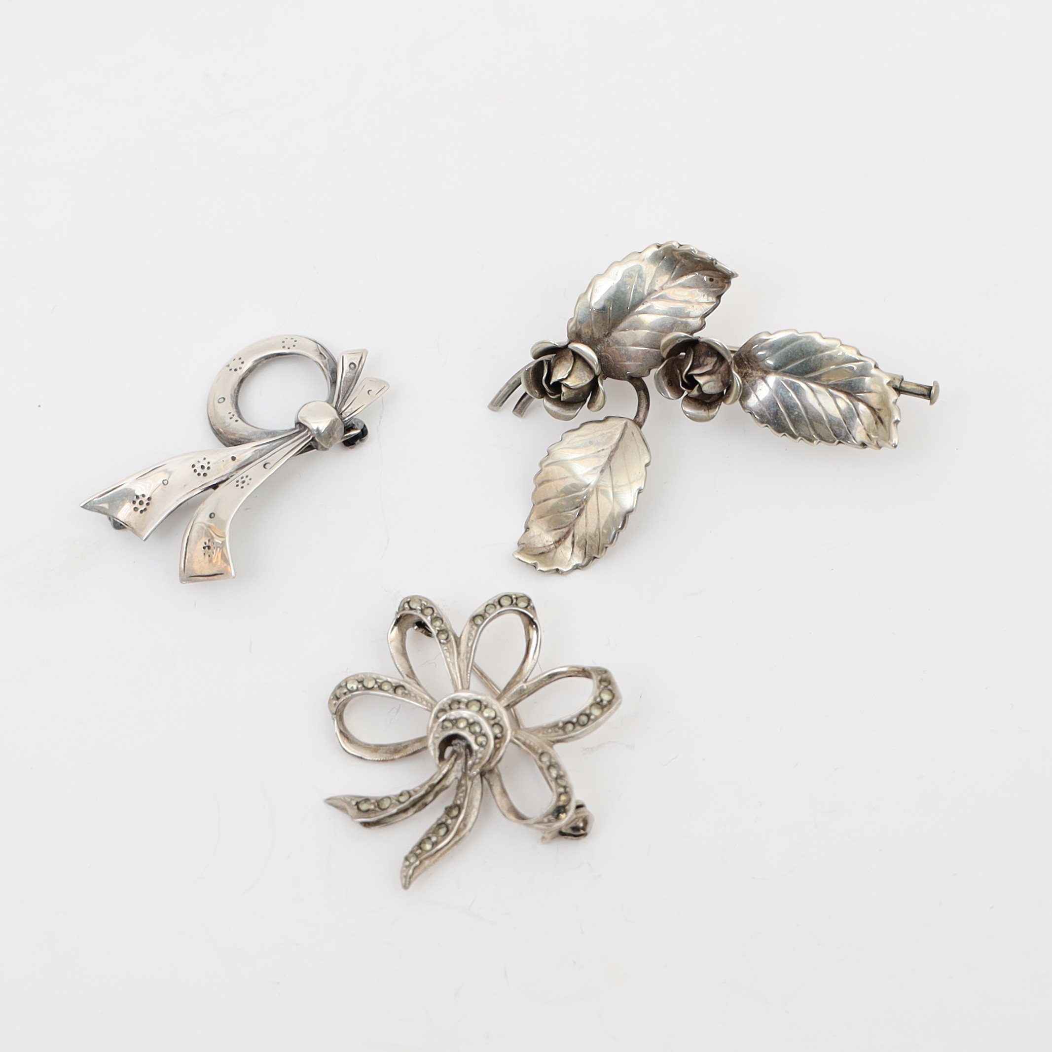 BROSCHER, 3st, silver, delvis med infattade markasiter.