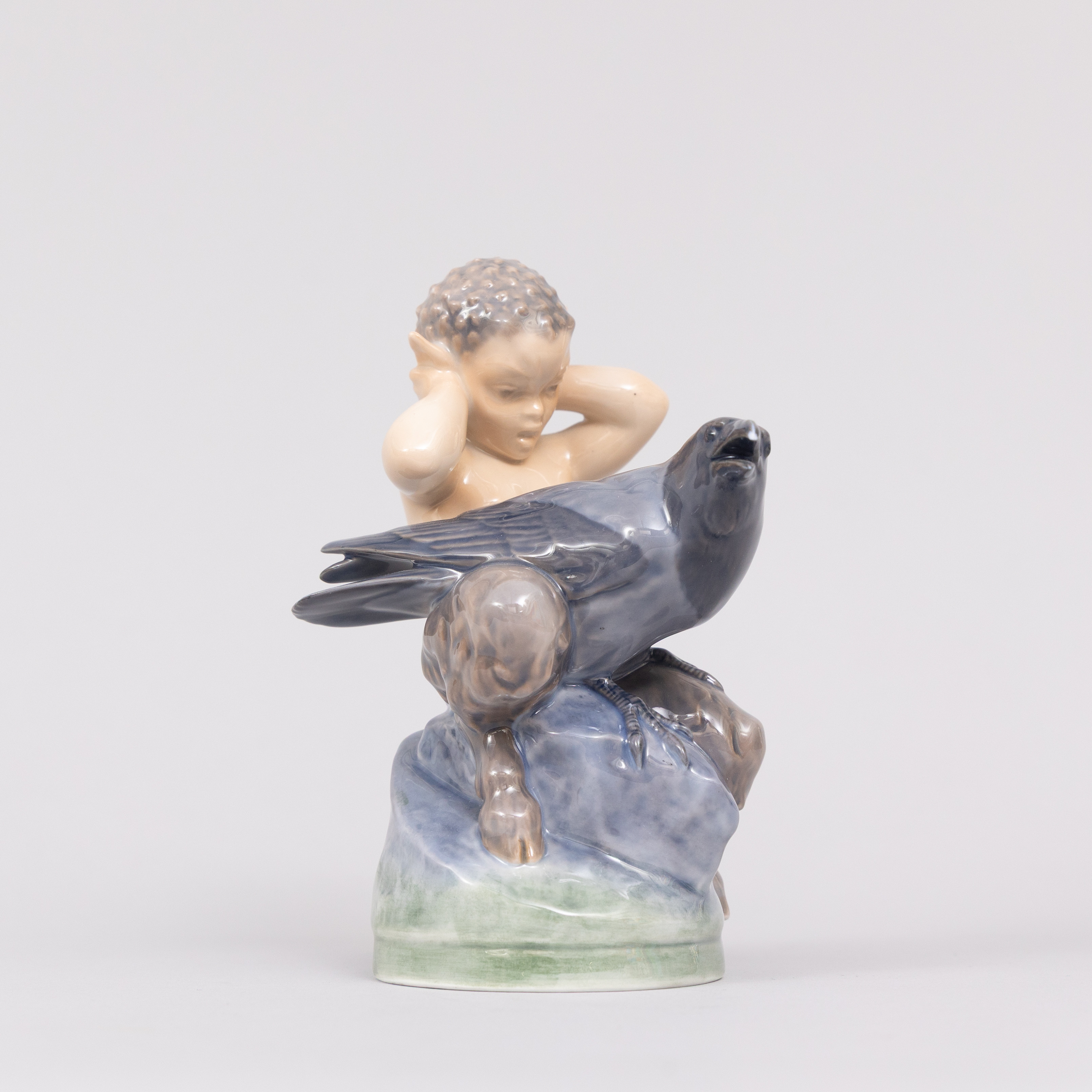 CHRISTIAN THOMSEN (DANMARK 1860-1921). Figurin, Faun med kråka, porslin, Royal Copenhagen, Denmark.