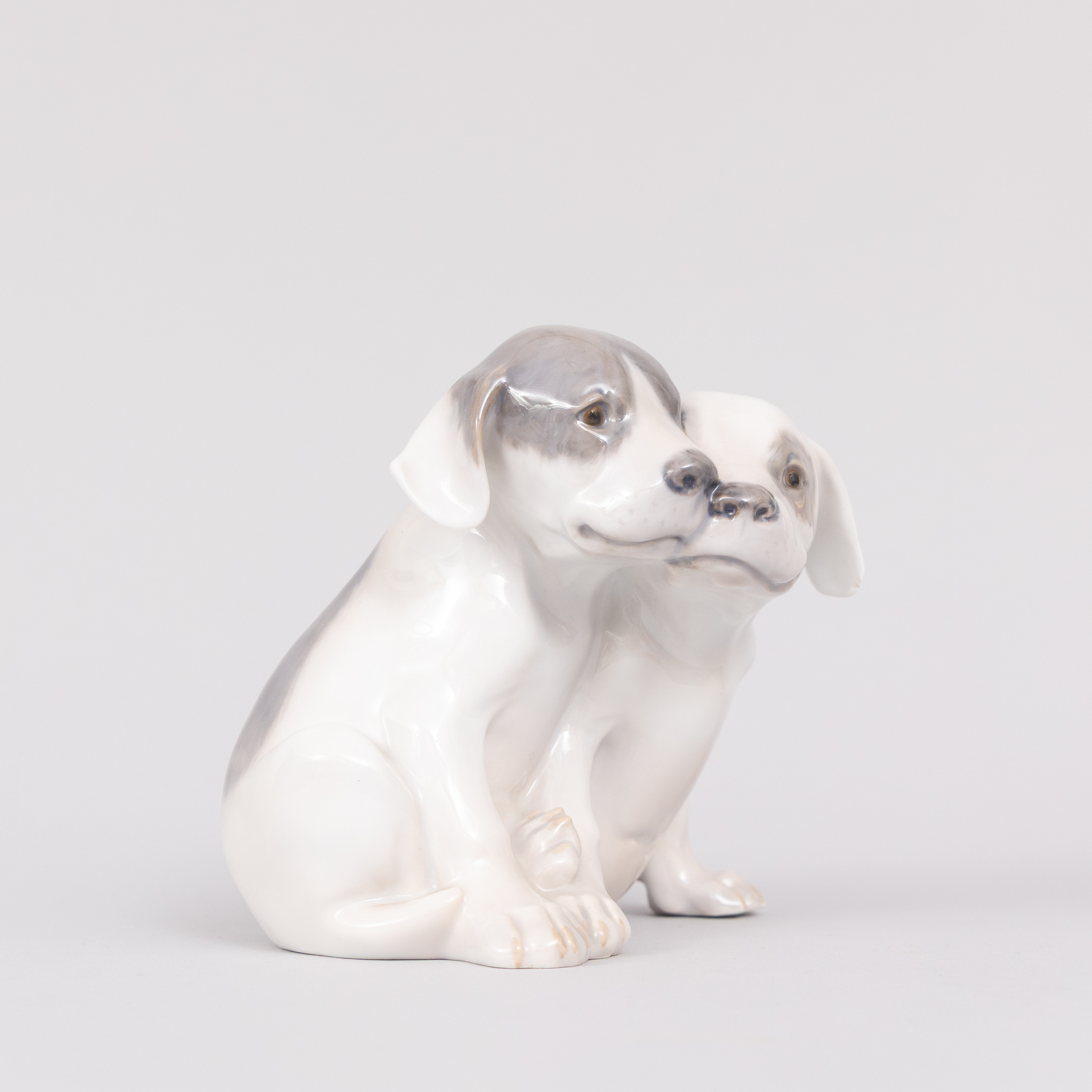 FIGURIN, två sittande hundvalpar, porslin, Royal Copenhagen, Denmark.