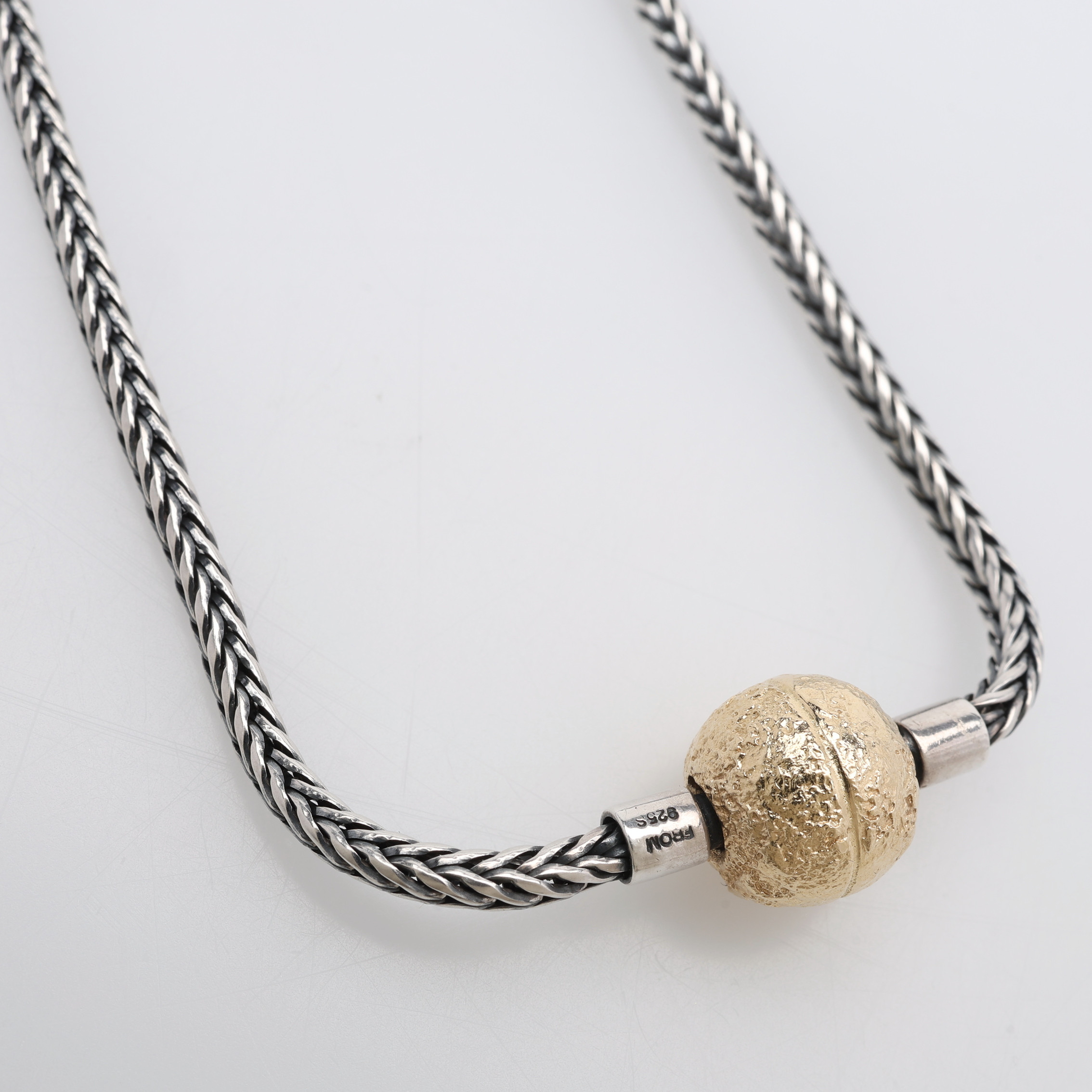 FLÄTAT SILVERCOLLIER MED KULLÅS AV 18 K GULD, kedjan märkt FROM 925 S, (sannolikt Niels Erik From), kullåset med bajonettfattning passande för kedjans dobbar (ej stämplat), vikt 27,5 och 3,7 g.