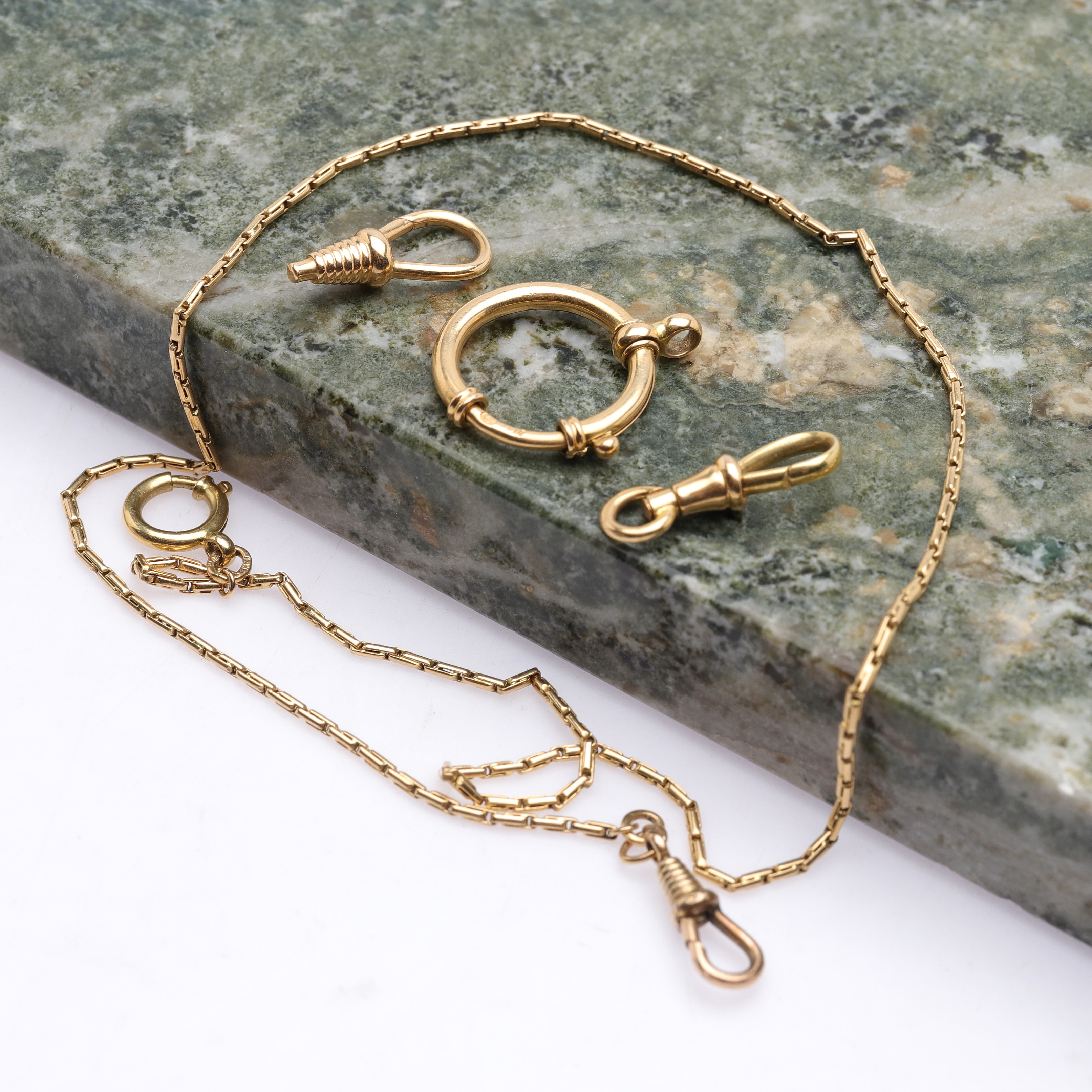 KLOCKKEDJA samt extra delar, 18k guld, totalvikt ca 14,58g.