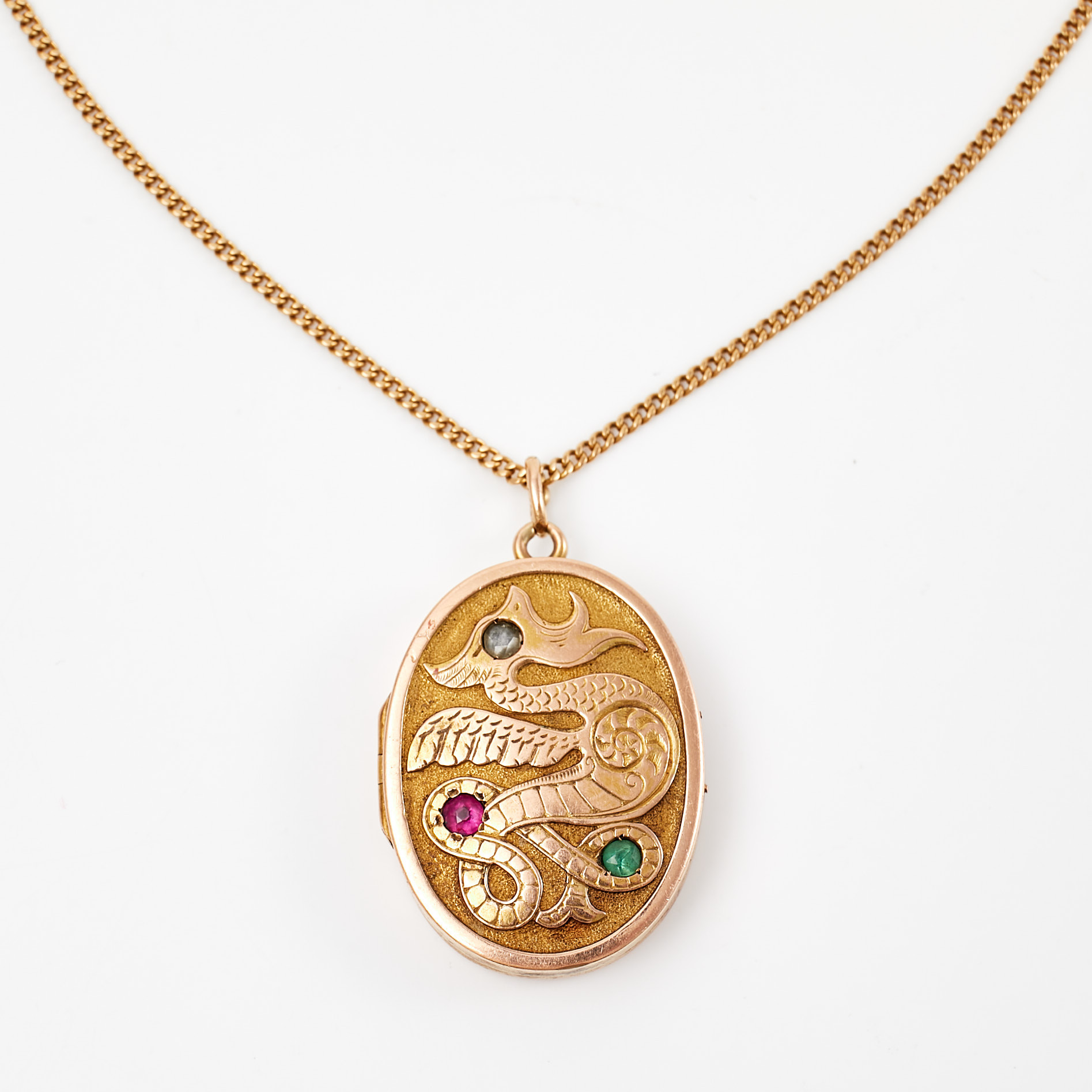 HALSBAND, 18 k guld, pansarlänk, behängd med MEDALJONG, 14 k guld, dekor av drakmotiv med 1 fasettslipad smaragd samt rubin, resp. rosenslipad diamant, Balestra, Italien samt svensk importstämpel.