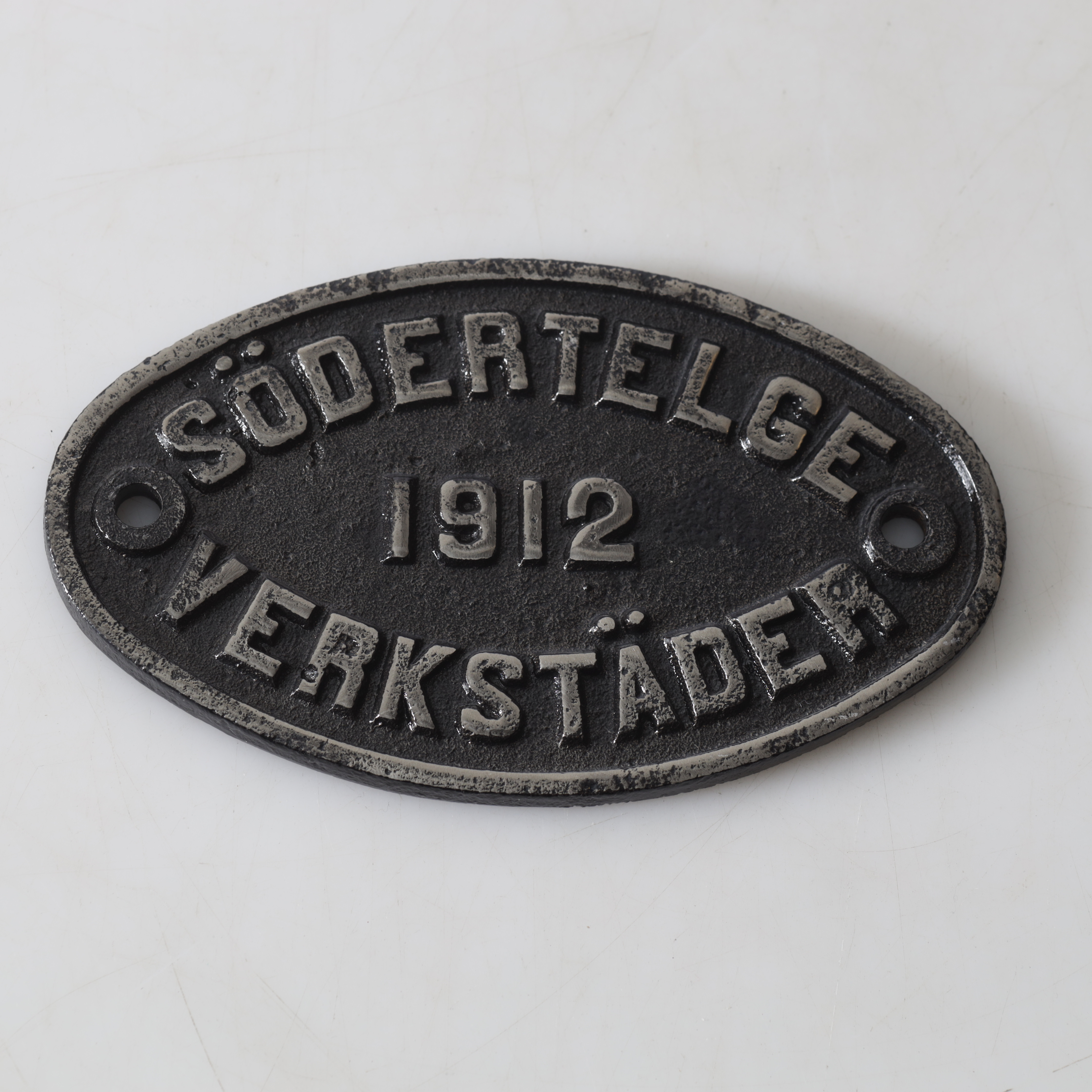 SKYLT, metall, Södertelge Verkstäder, 1912.