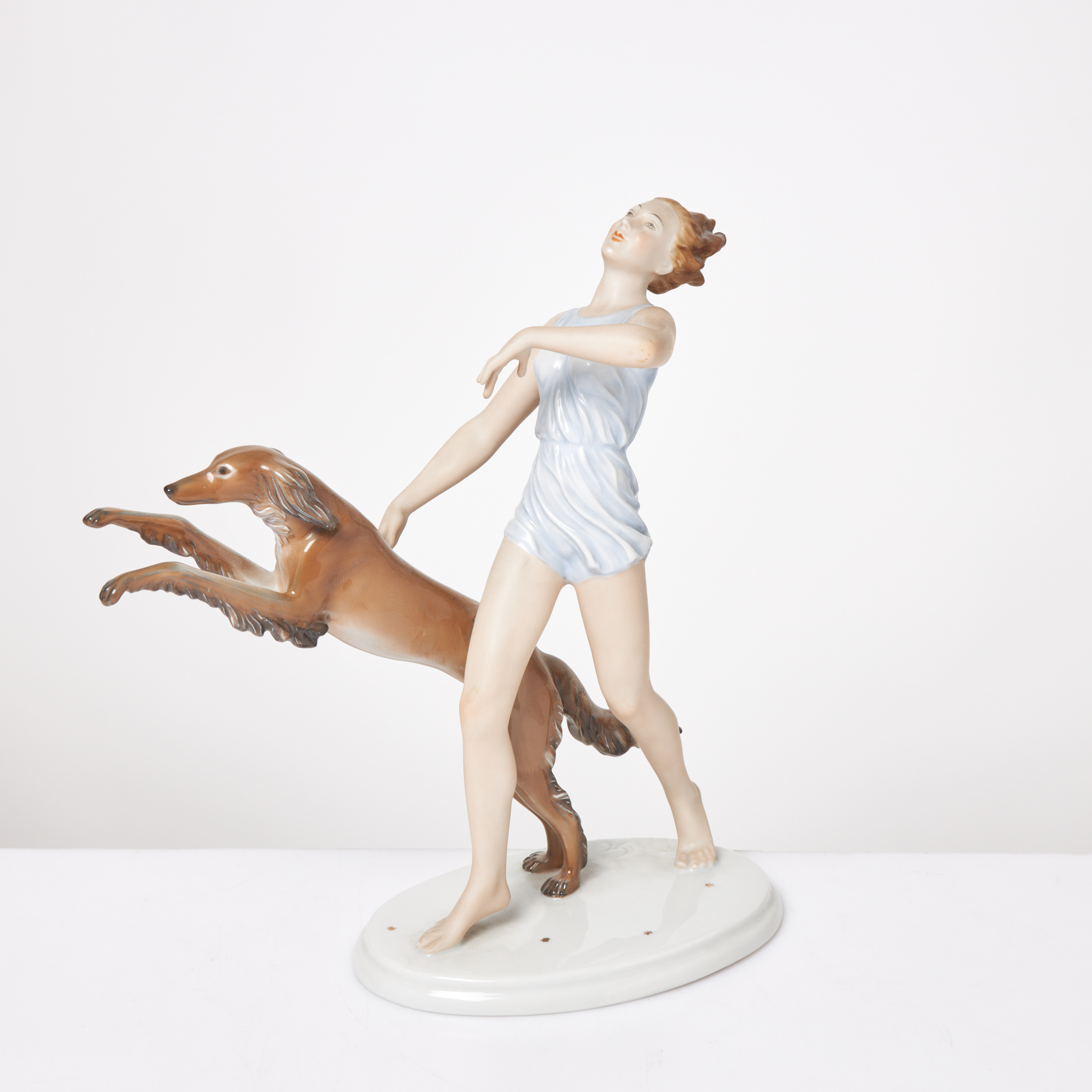 GUSTAV OPPEL. Figurin, kvinna med hund, porslin, monogramsignerad i godset, Rosenthal, Tyskland, 1900-tal.